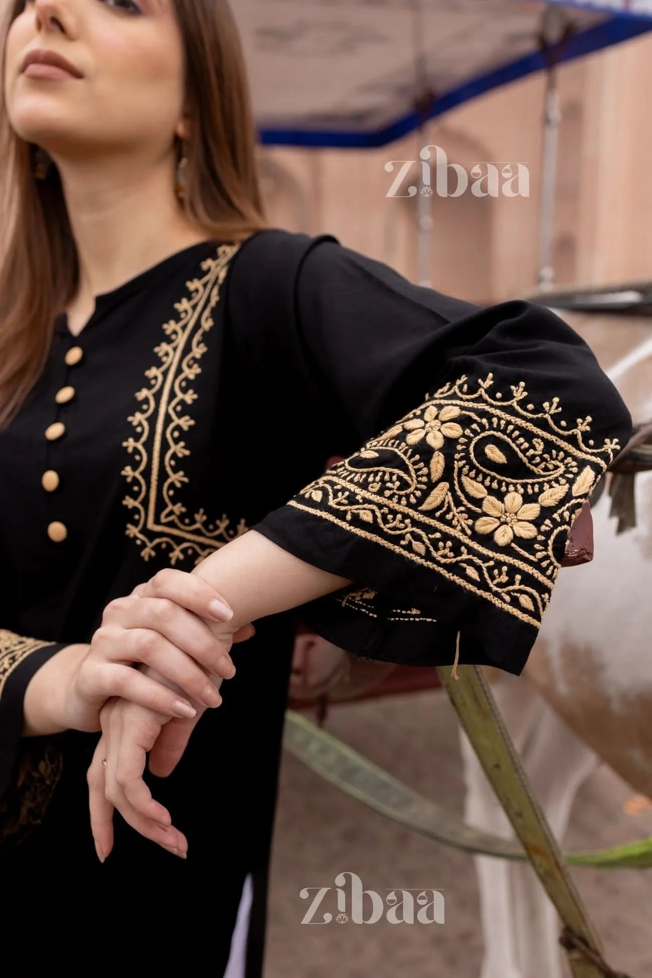 Close-up of black chikankari kurti showing detailed floral embroidery.