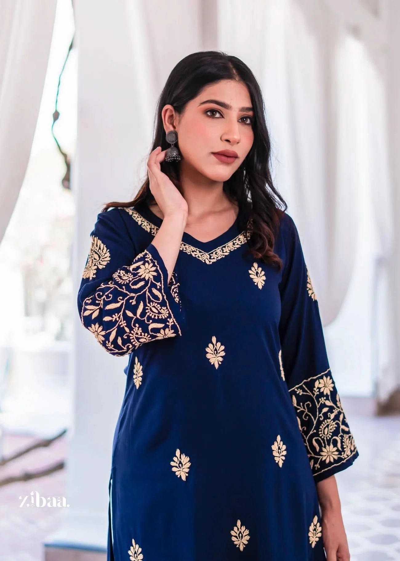 A chic blue kurta with golden embroidery on the neckline and sleeves.
The V-neck cut blends modern style with ethnic wear charm.
An elegant traditional outfit for festive wear and cultural events.