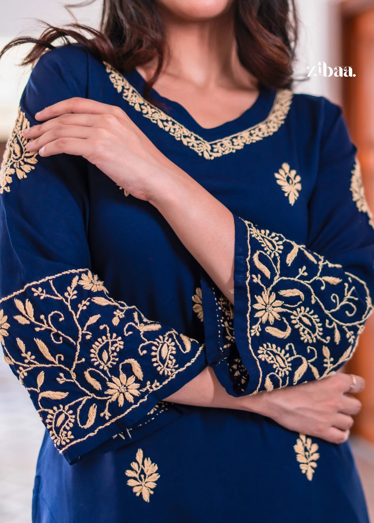 classic blue kurta showcasing golden embroidery on the sleeves.
The detailed threadwork adds a rich traditional outfit touch.
Ideal ethnic wear for festive occasions and formal gatherings.