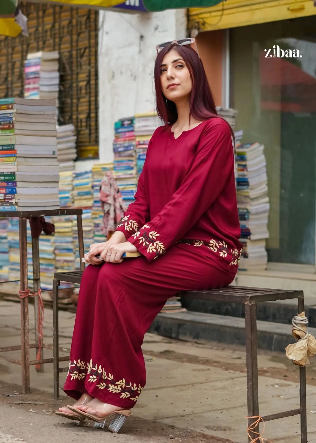 Outdoor pose of model dressed in a burgundy chikankari coord set with visible embroidery details.