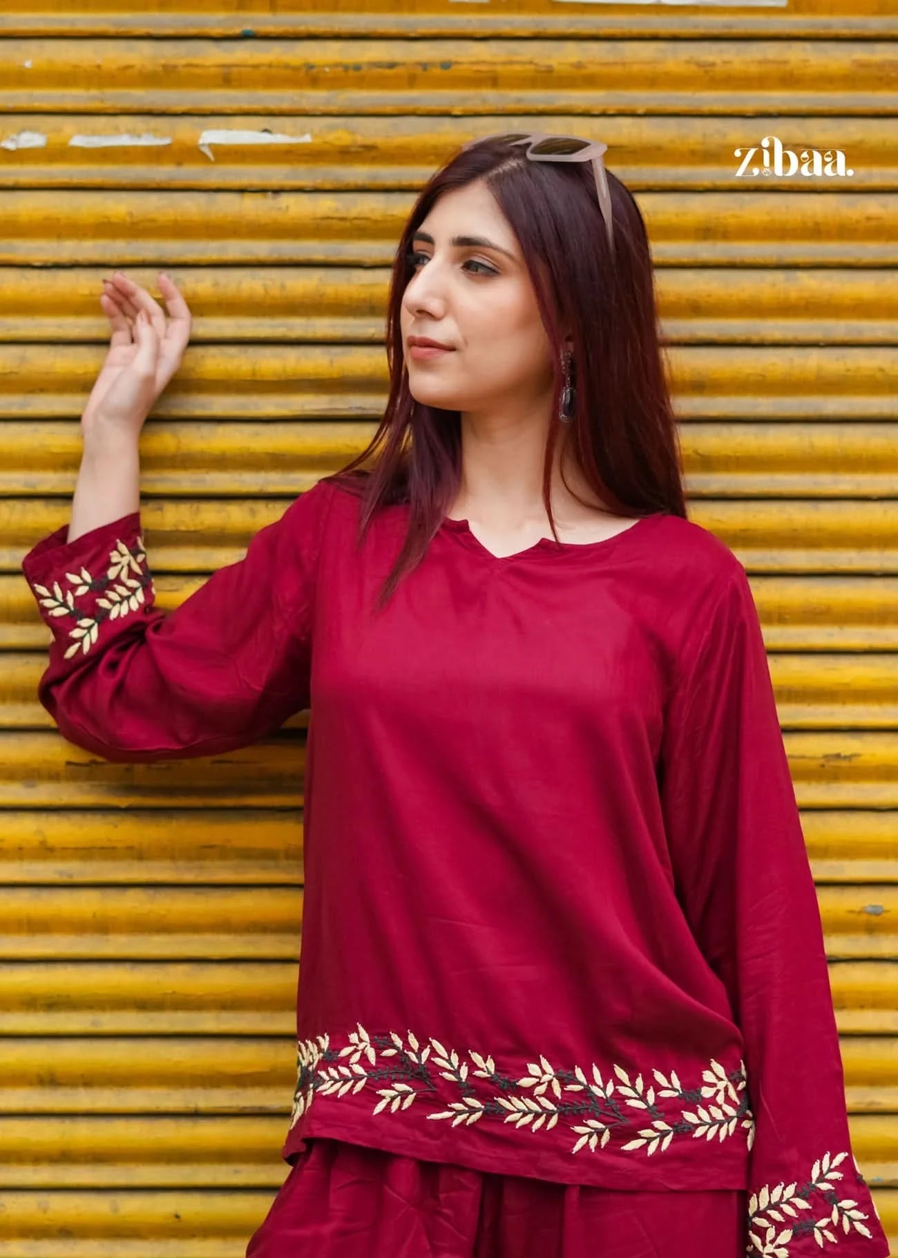 Model outdoors showcasing a burgundy chikankari coord set with intricate threadwork.