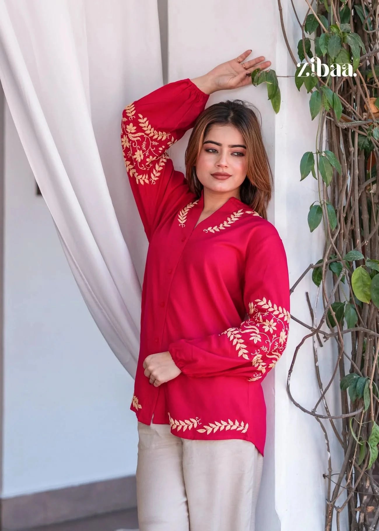 The model poses outdoors in a hot pink chikankari kurti, showcasing the intricate chikankari stitch work with ease.