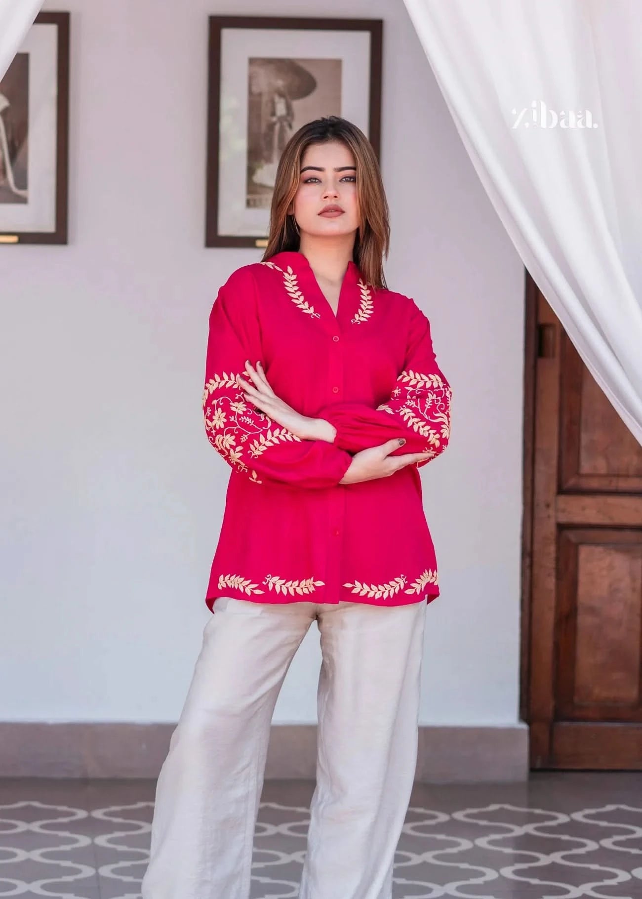 Model wearing a pink chikankari kurti, posing outdoors with embroidery details visible.