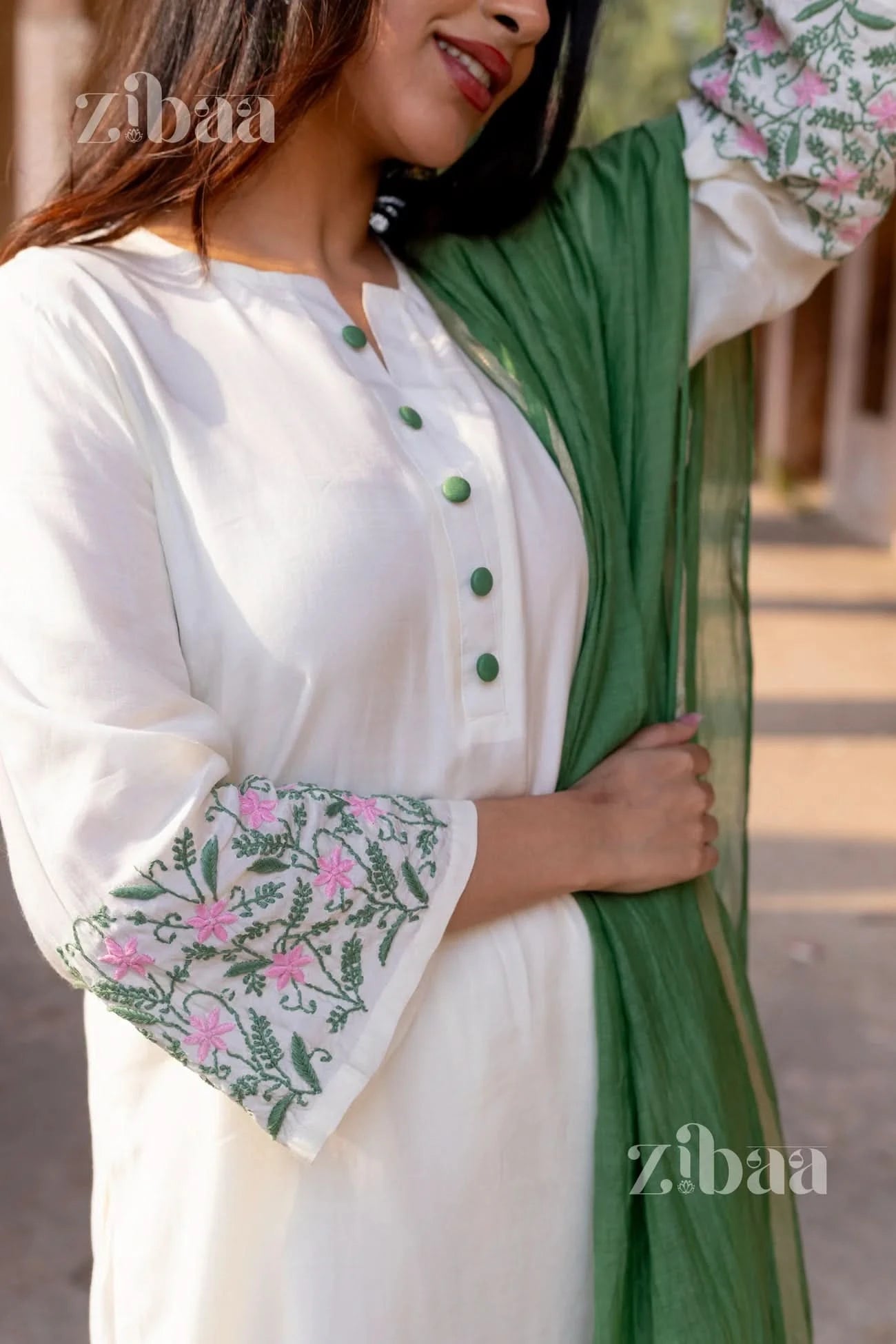 Floral embroidered White Chikankari Kurta Set paired with sage green mulmul dupatta, worn by a woman.