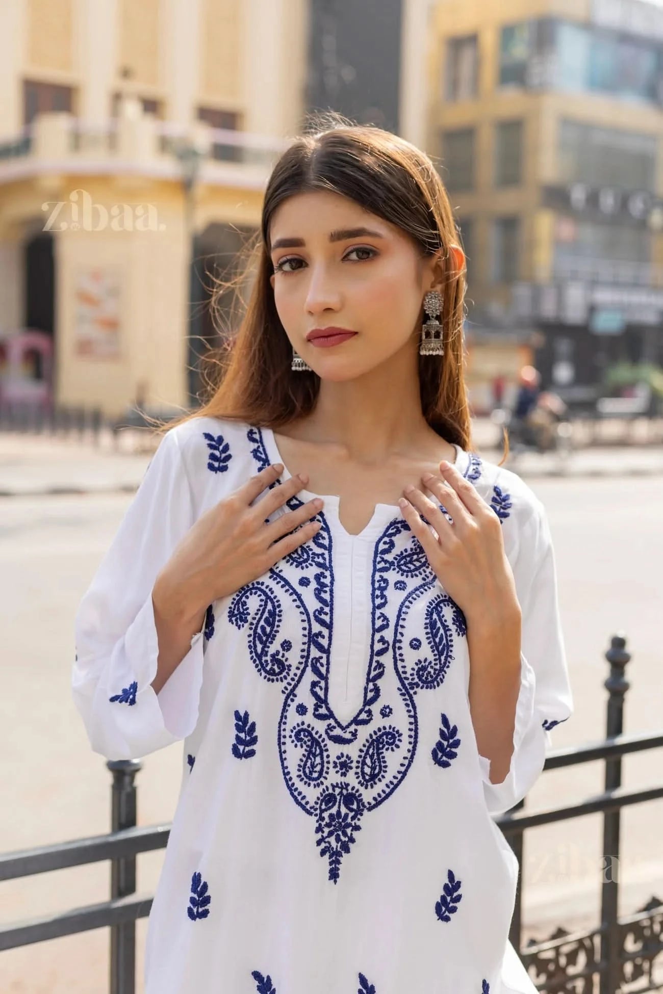Front view of a white Chikankari Kurti with intricate blue embroidery, styled elegantly, perfect for a modern yet traditional look