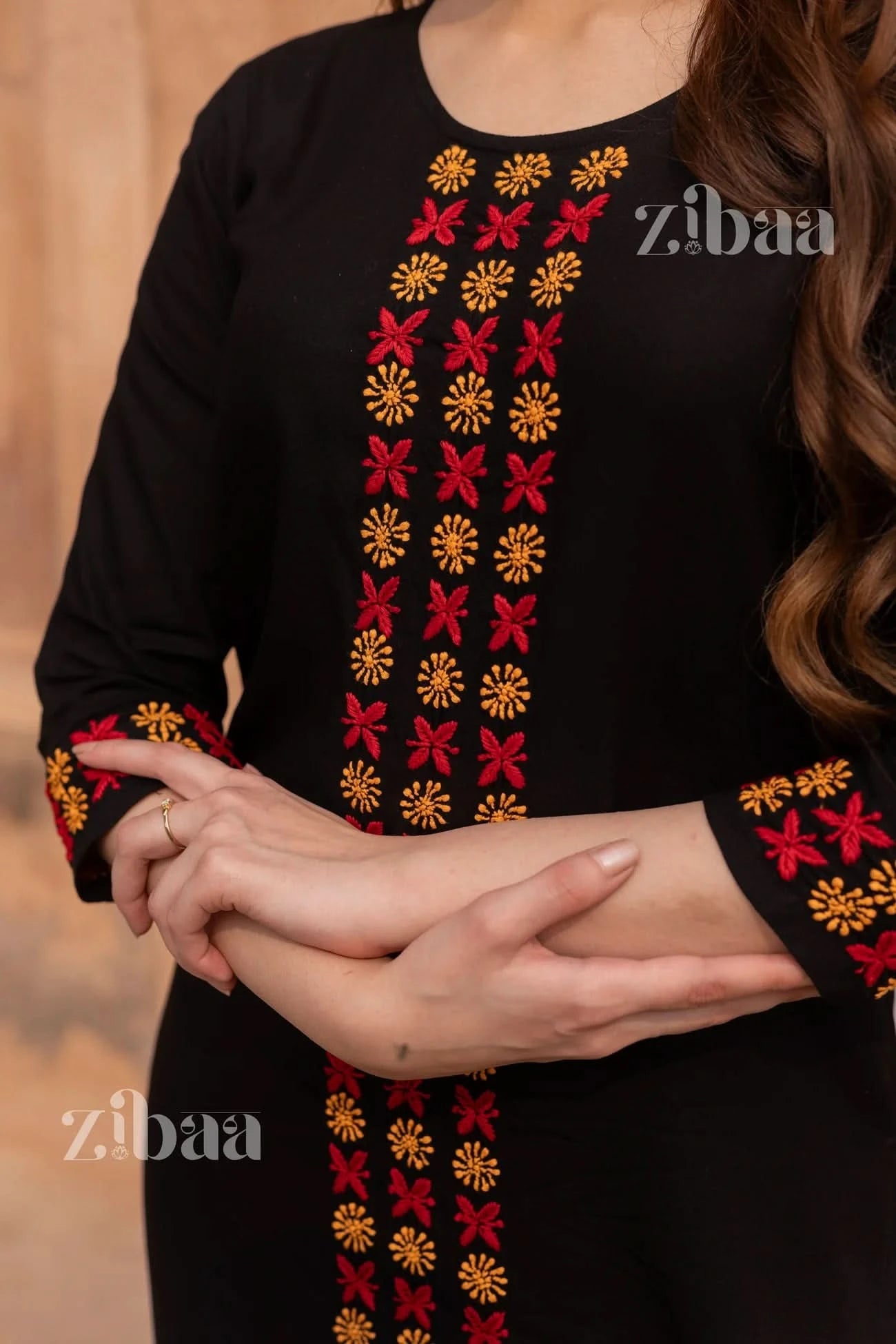 Close-up image of black chikankari kurti set focusing on floral chikankari embroidery.