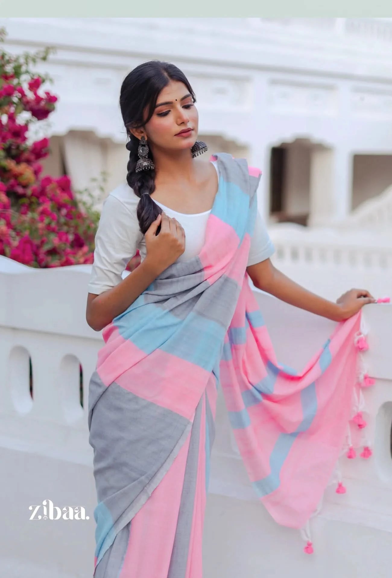 Woman wearing a colorful saree with a white background