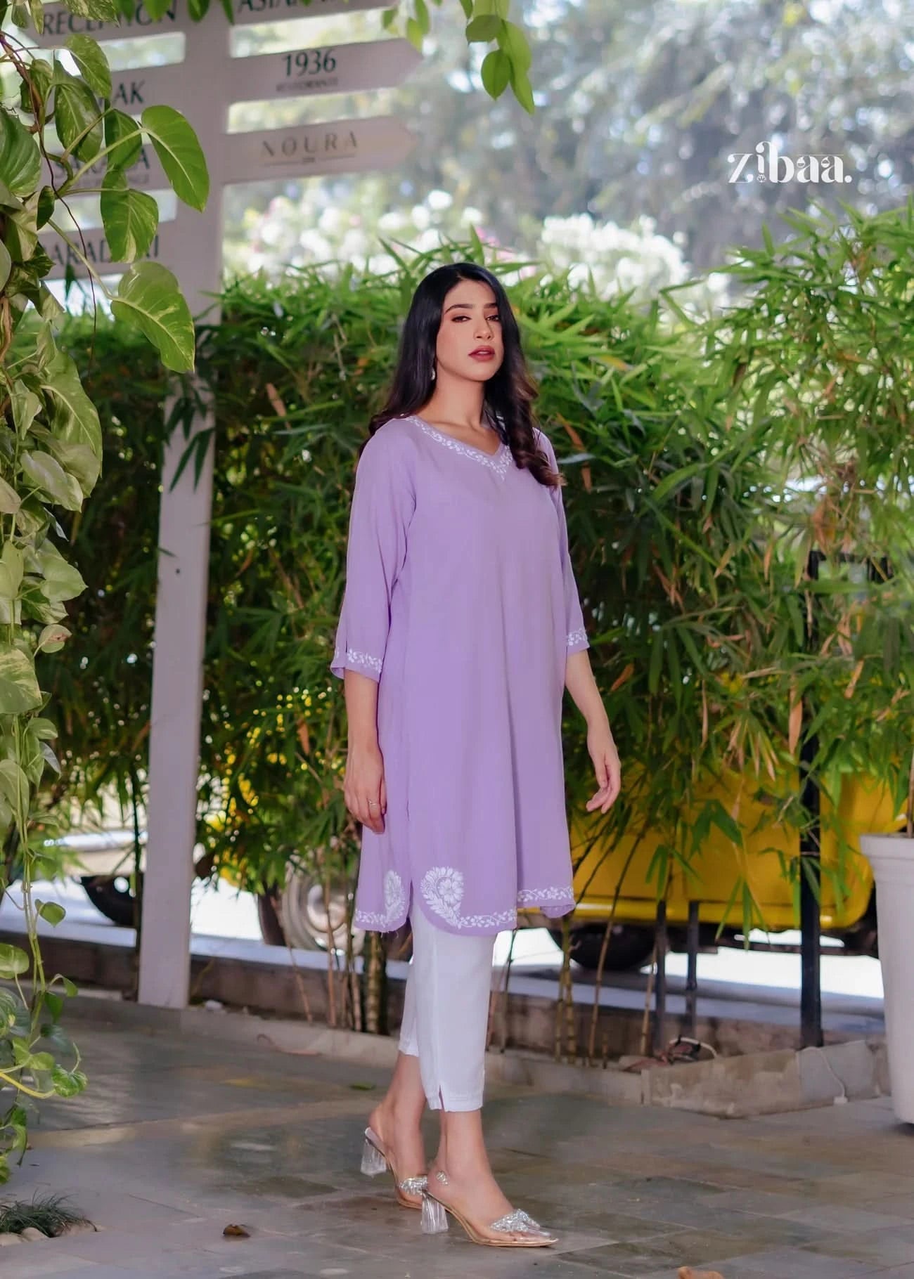 The model stands stylishly outdoors in an Elegant Husn Lavender Chikankari Co-ord Set for Women. Elegant Husn Lavender Chikankari Co-ord Set for Women combines comfort with traditional embroidery. The lavender hue creates a soothing festive look.