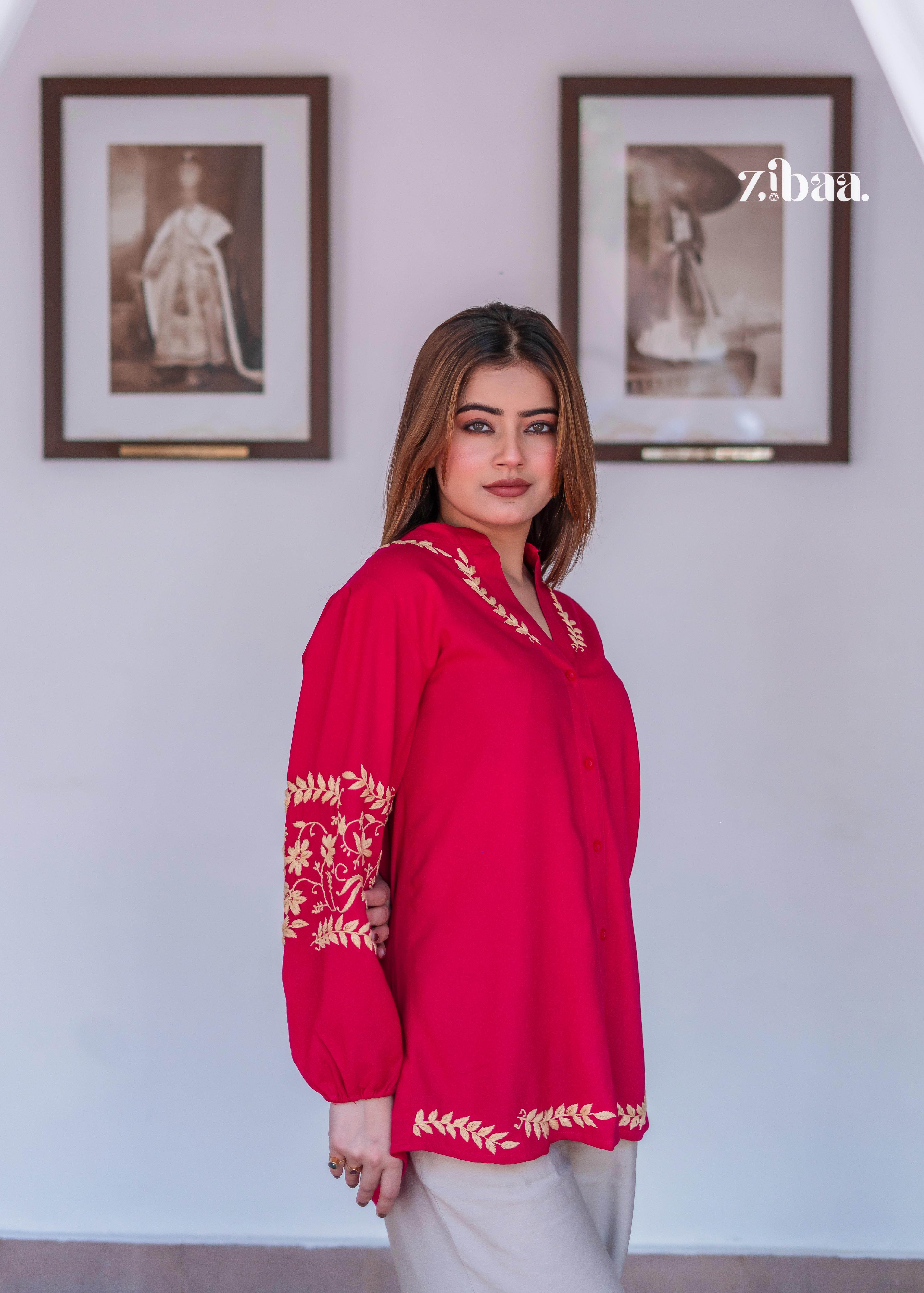 The model is standing confidently in an Elegant Pink Kurta with Beige Trousers. Elegant Pink Kurta with Beige Trousers highlights rich sleeve embroidery in gold. This look blends festive charm with everyday ease.