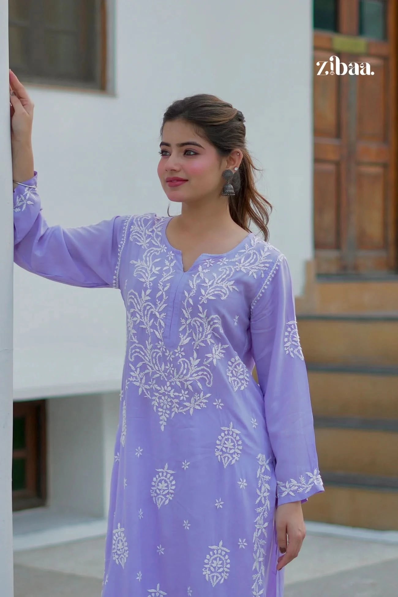 Model wearing a lavender chikankari kurti with visible hand embroidery, photographed outdoors.