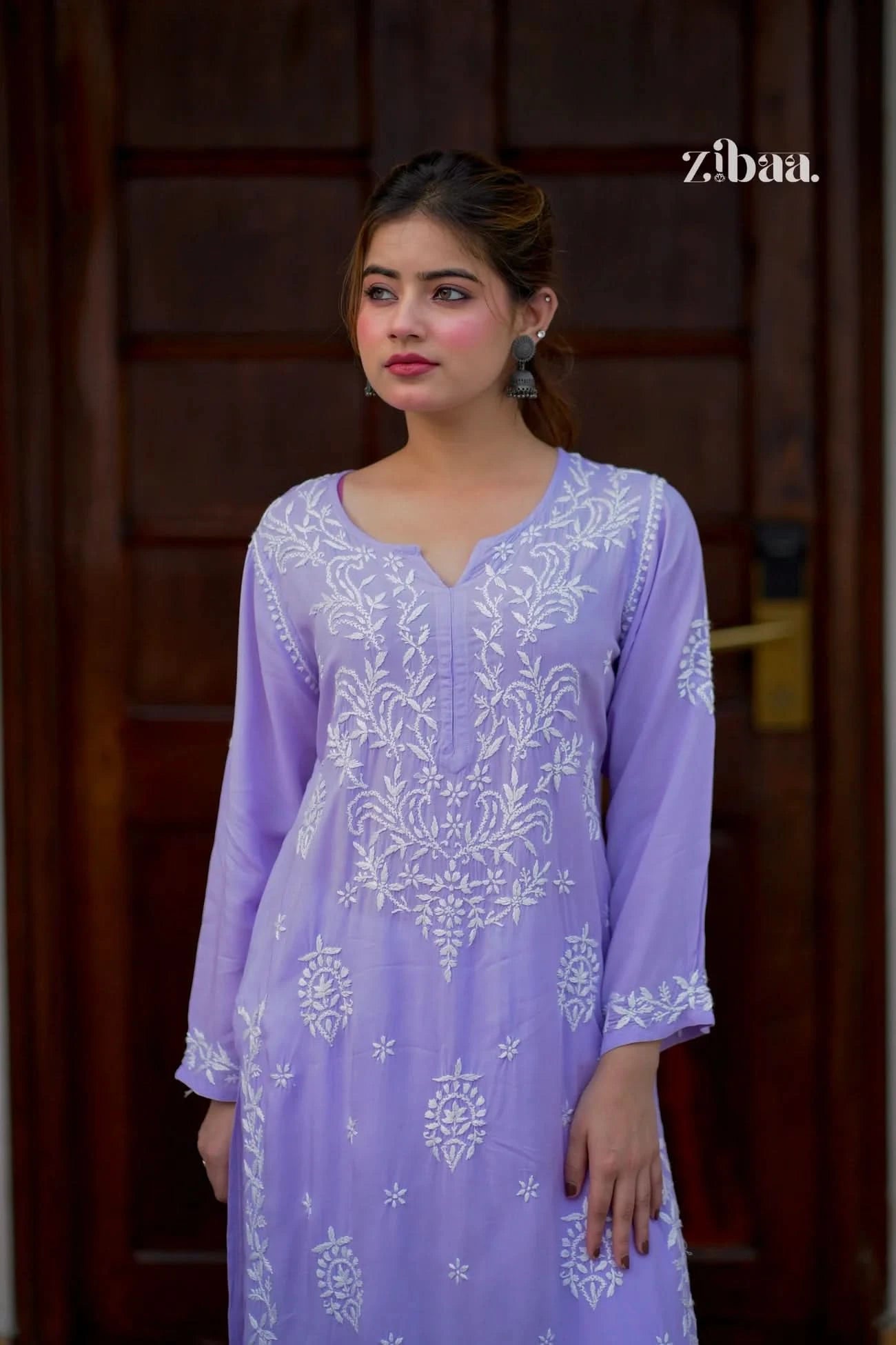 Lavender chikankari kurti with fine traditional embroidery worn by a model in an outdoor setting.