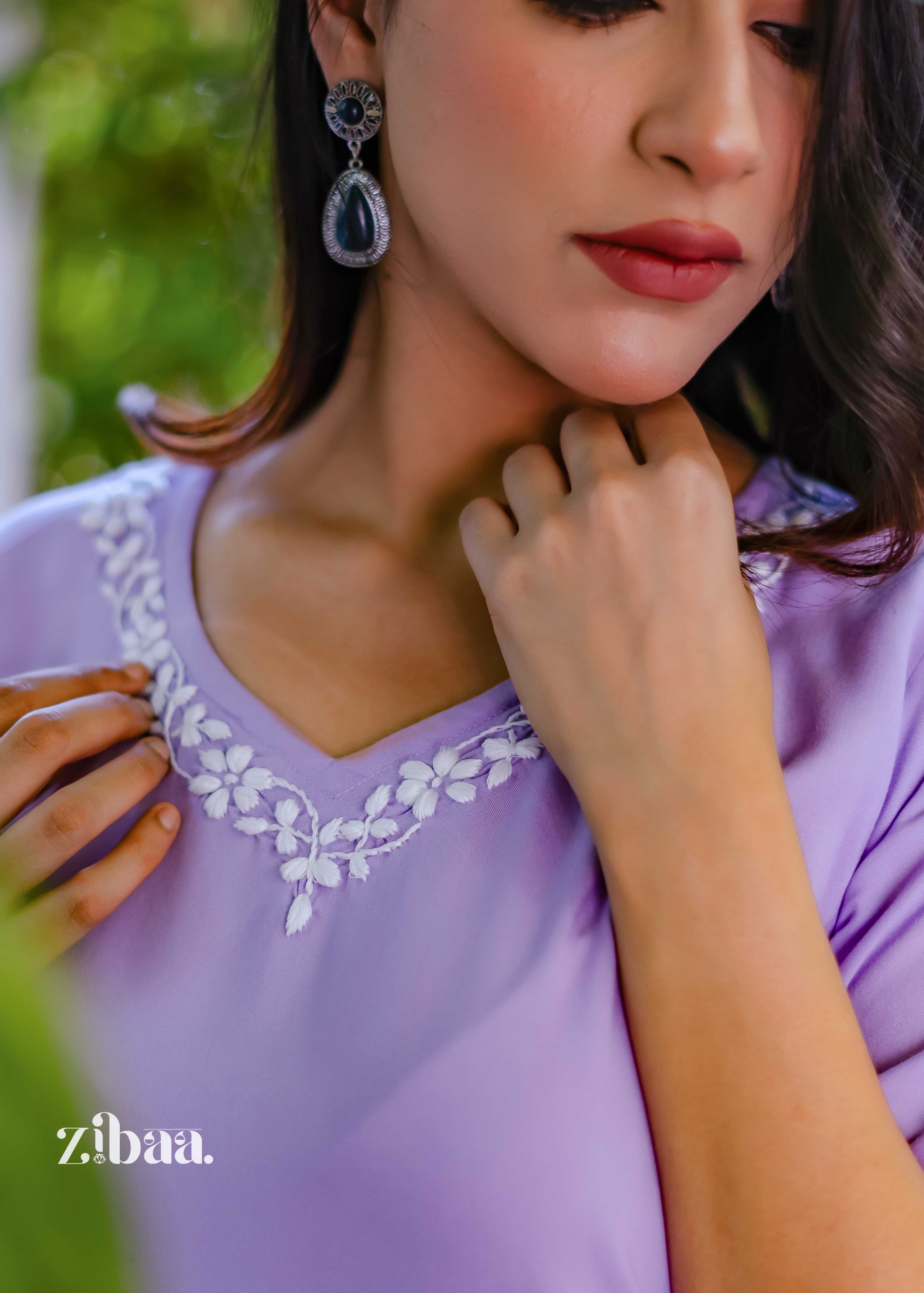 A close-up focuses on the neckline of the lavender chikankari kurti, bringing out the fine embroidery and delicate threadwork.
