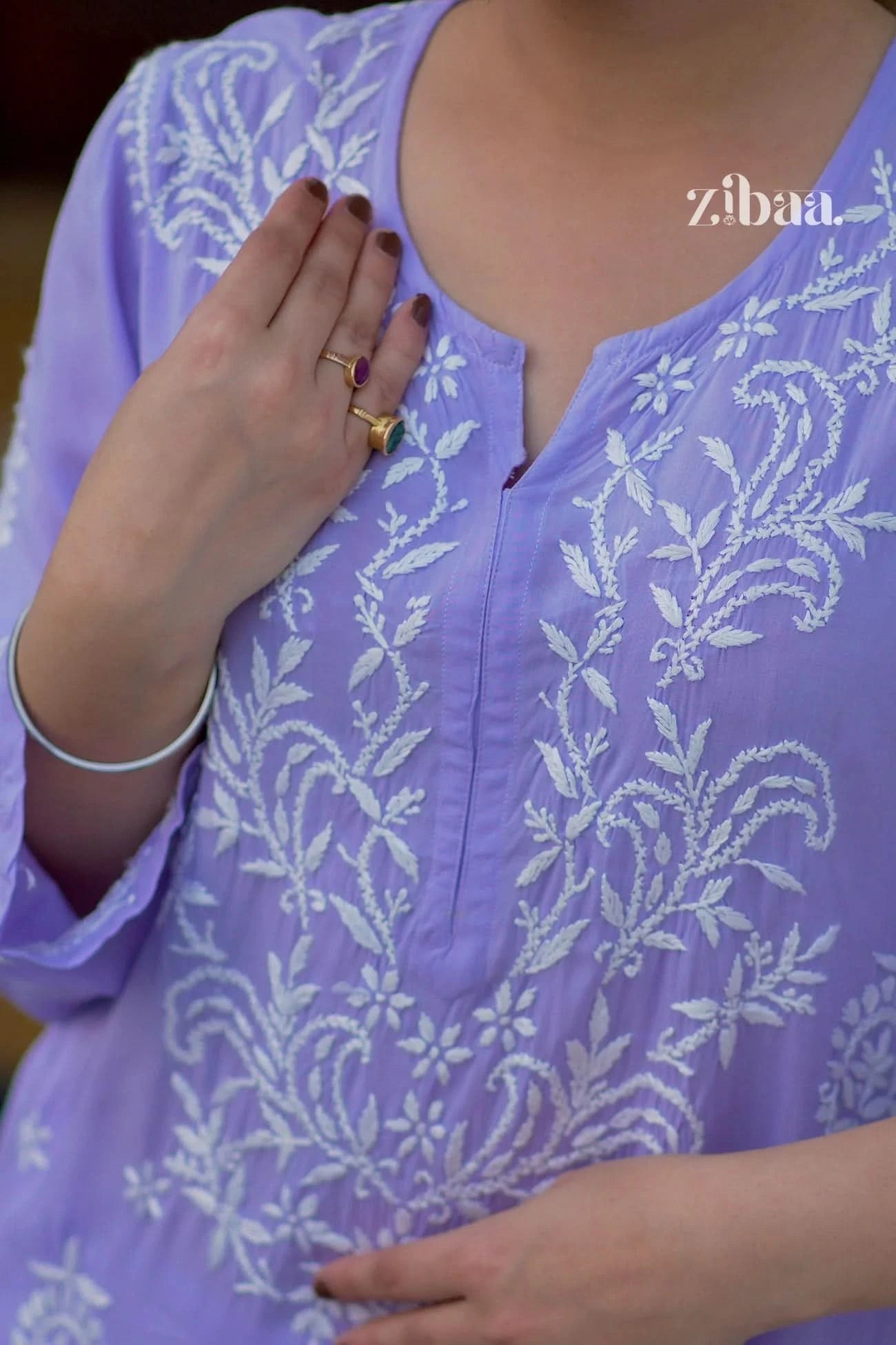 Close-up of a lavender chikankari kurti on a model outdoors, showing delicate hand-stitched detailing.