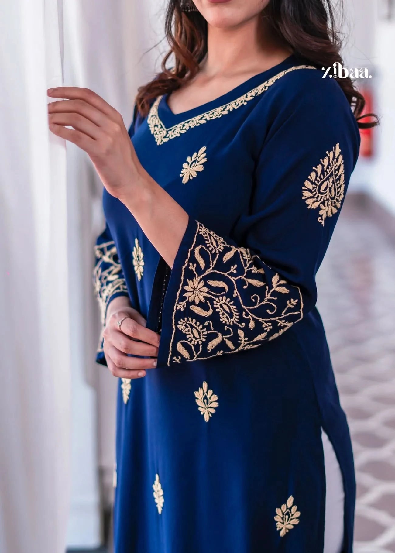 A detailed blue kurta with golden embroidery around the neckline.
The fine craftsmanship makes it an elegant ethnic wear choice. Perfect traditional outfit for festive wear and celebrations.