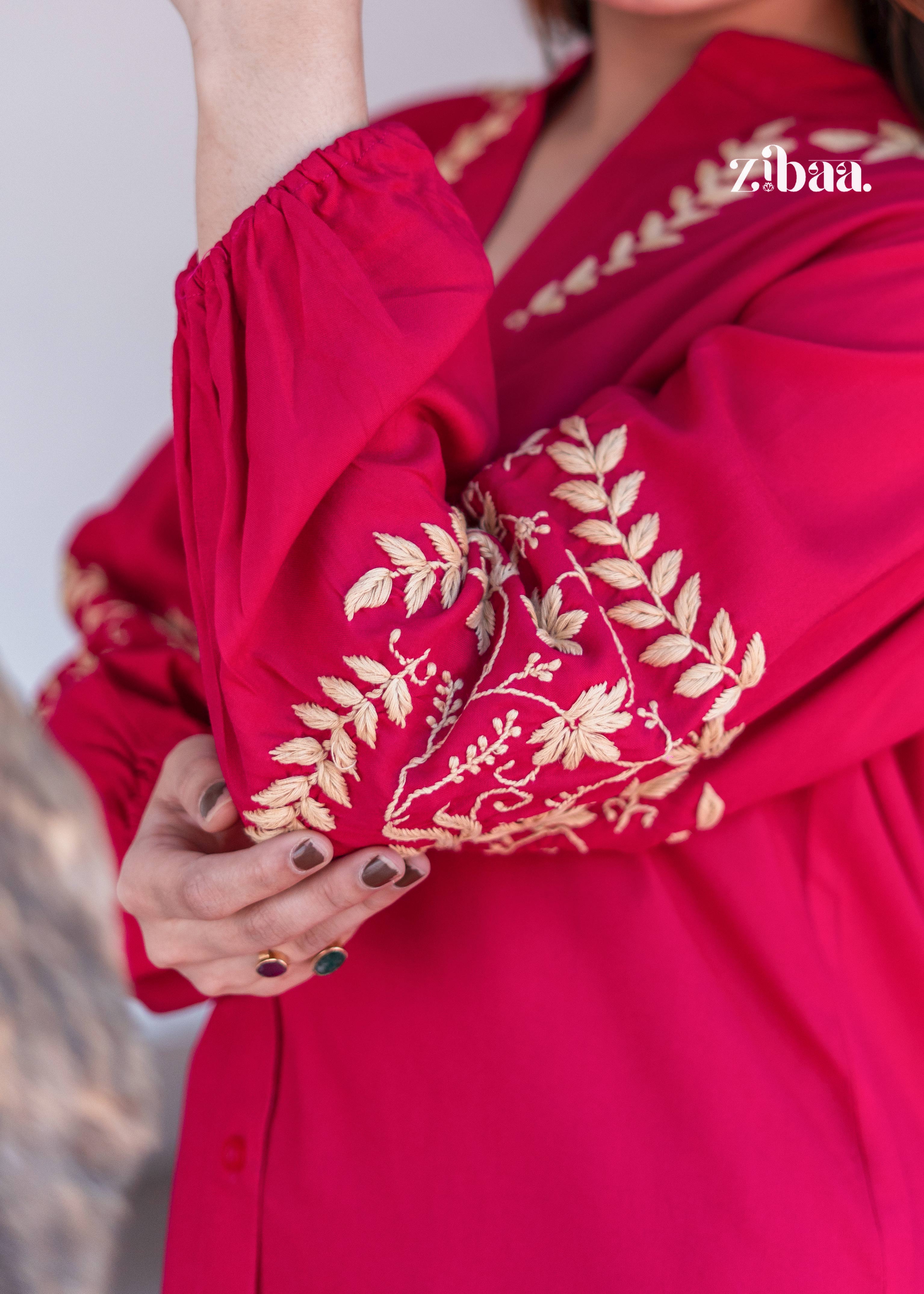 The model is highlighting the delicate golden motifs on the sleeve of a Pink Kurta with Intricate Sleeve Detailing. Pink Kurta with Intricate Sleeve Detailing is styled with simple beige pants. The close-up captures the fine craftsmanship perfectly.