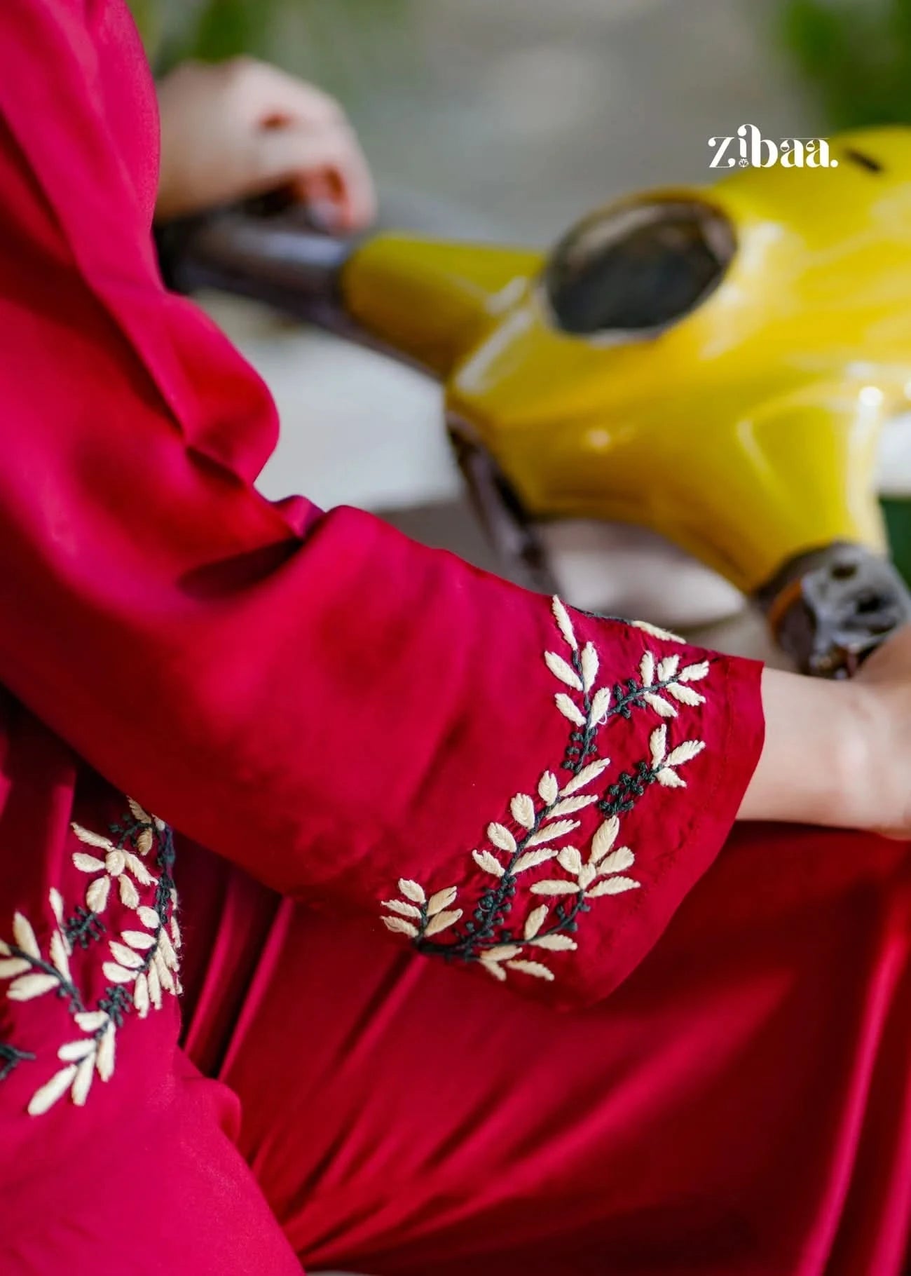 A close-up of the model’s hands shows a Deep Burgundy Co-ord Set with Sleeve Embroidery.