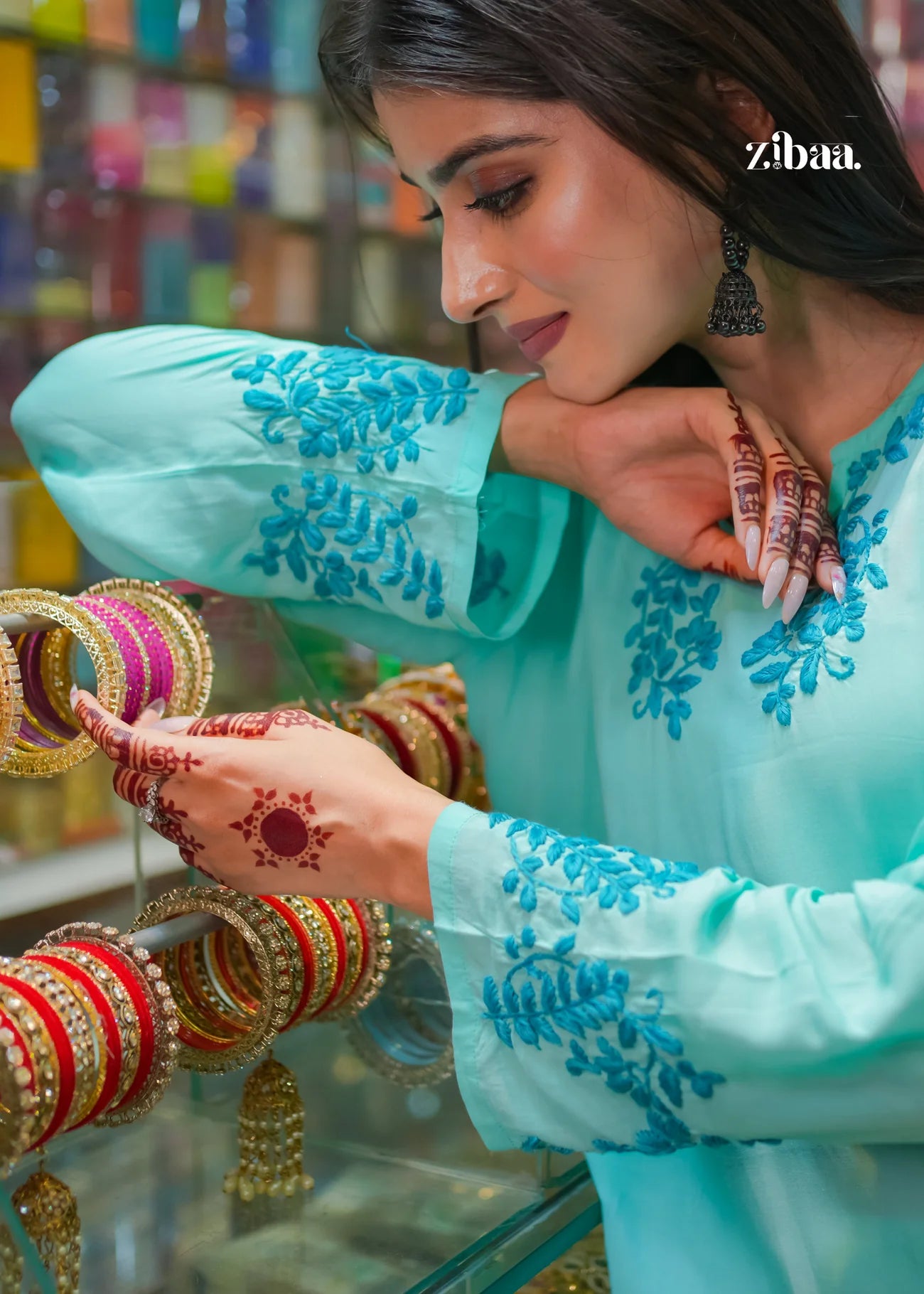 The model holds bangles while detailed close-up shots highlight the intricate embroidery of the blue chikankari kurti, showcasing elegance and craftsmanship