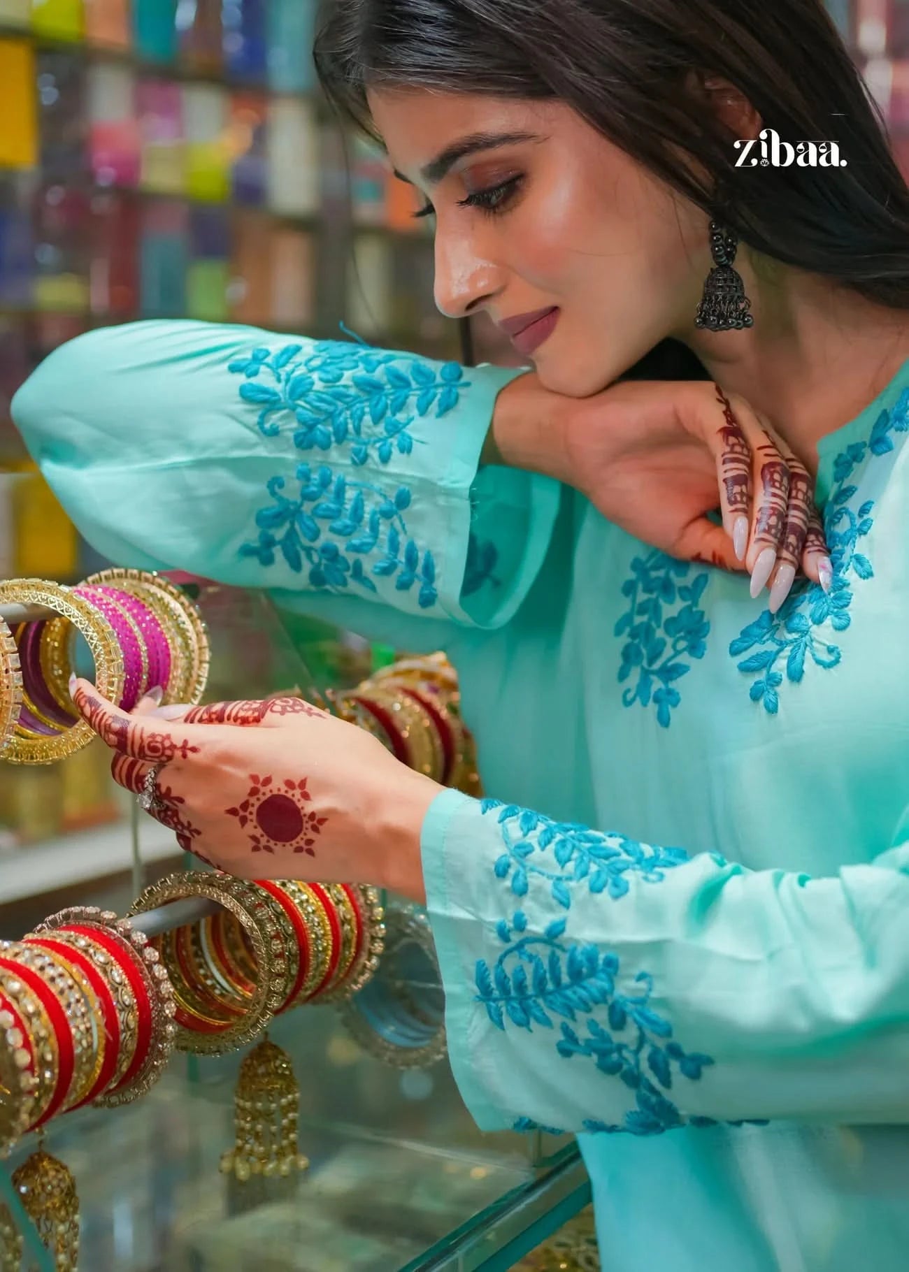 The model holds bangles while detailed close-up shots highlight the intricate embroidery of the blue chikankari kurti, showcasing elegance and craftsmanship