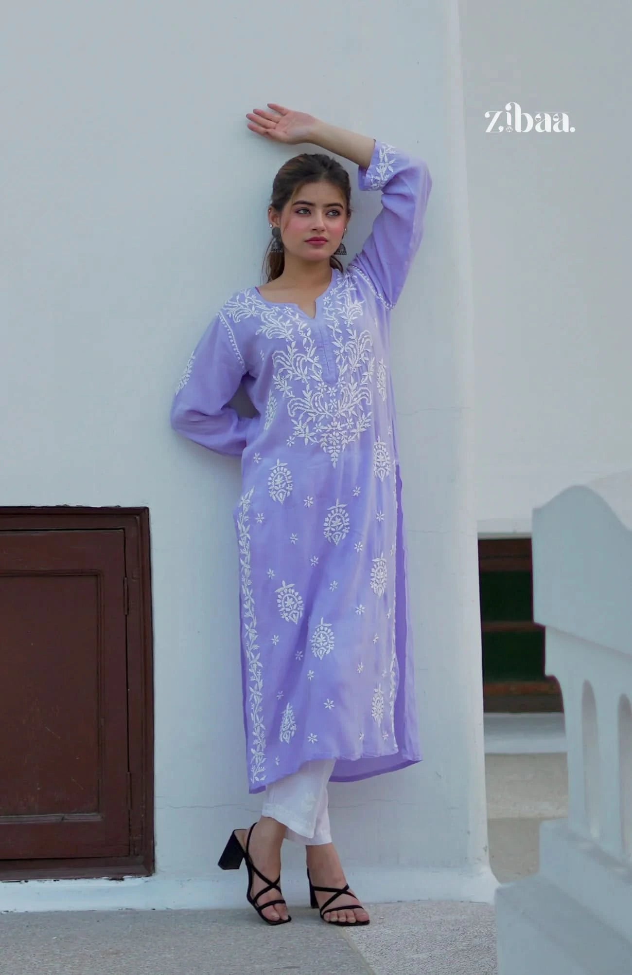 Hand-embroidered lavender chikankari kurti worn by a model, captured in an outdoor setting.