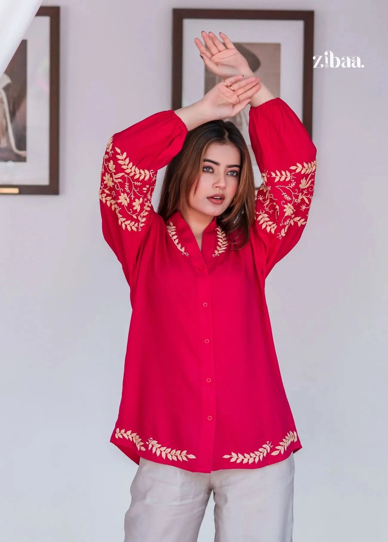 Model outdoors wearing pink chikankari kurti with golden embroidery.