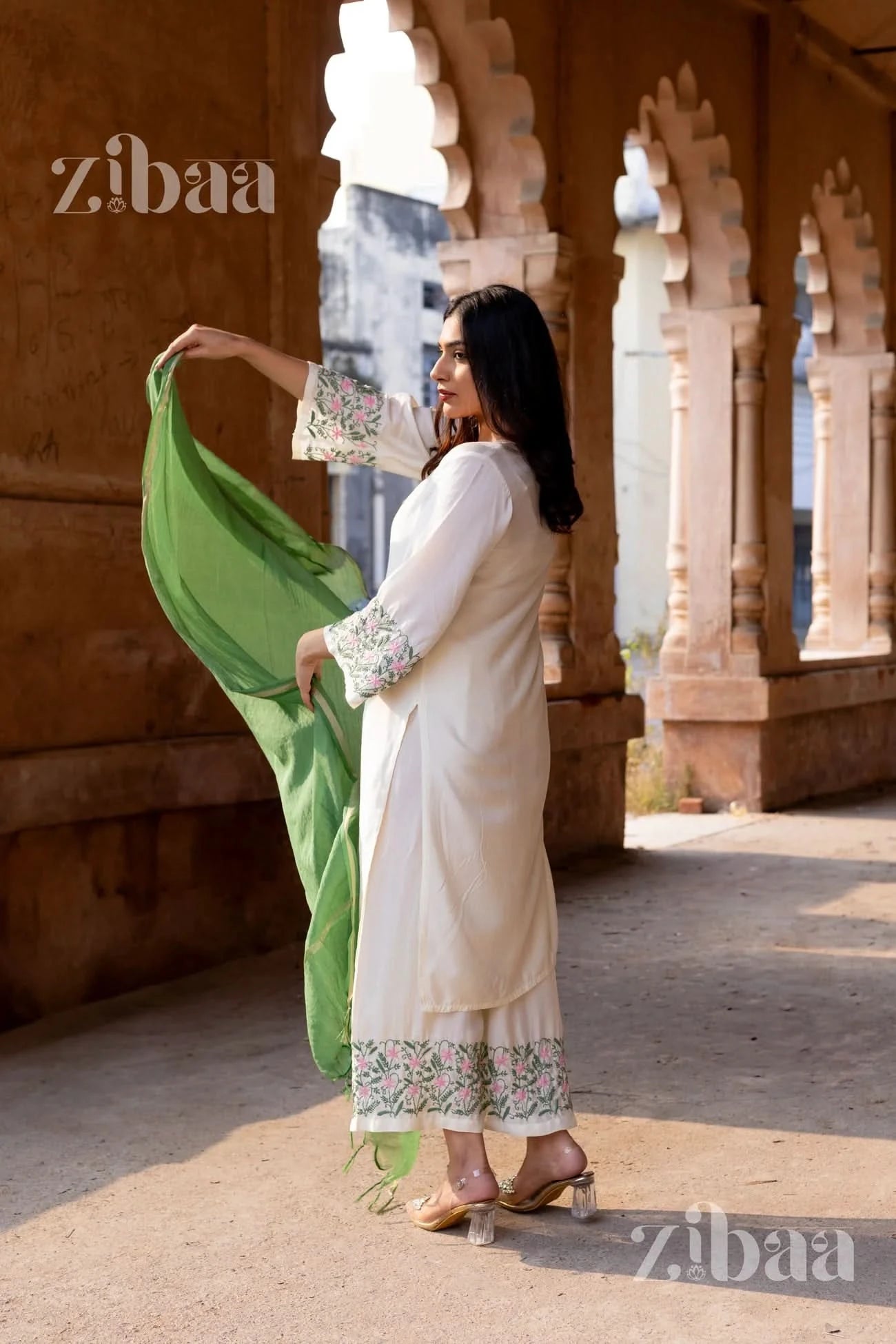 Model wearing a White Chikankari Kurta Set in pure muslin, paired with a sage green mulmul dupatta.