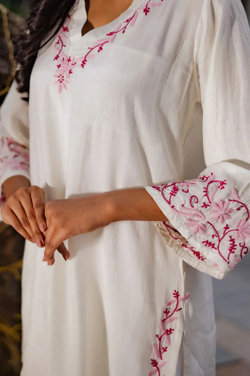 Zoomed-in view of white chikankari kurti showcasing fine floral threadwork.