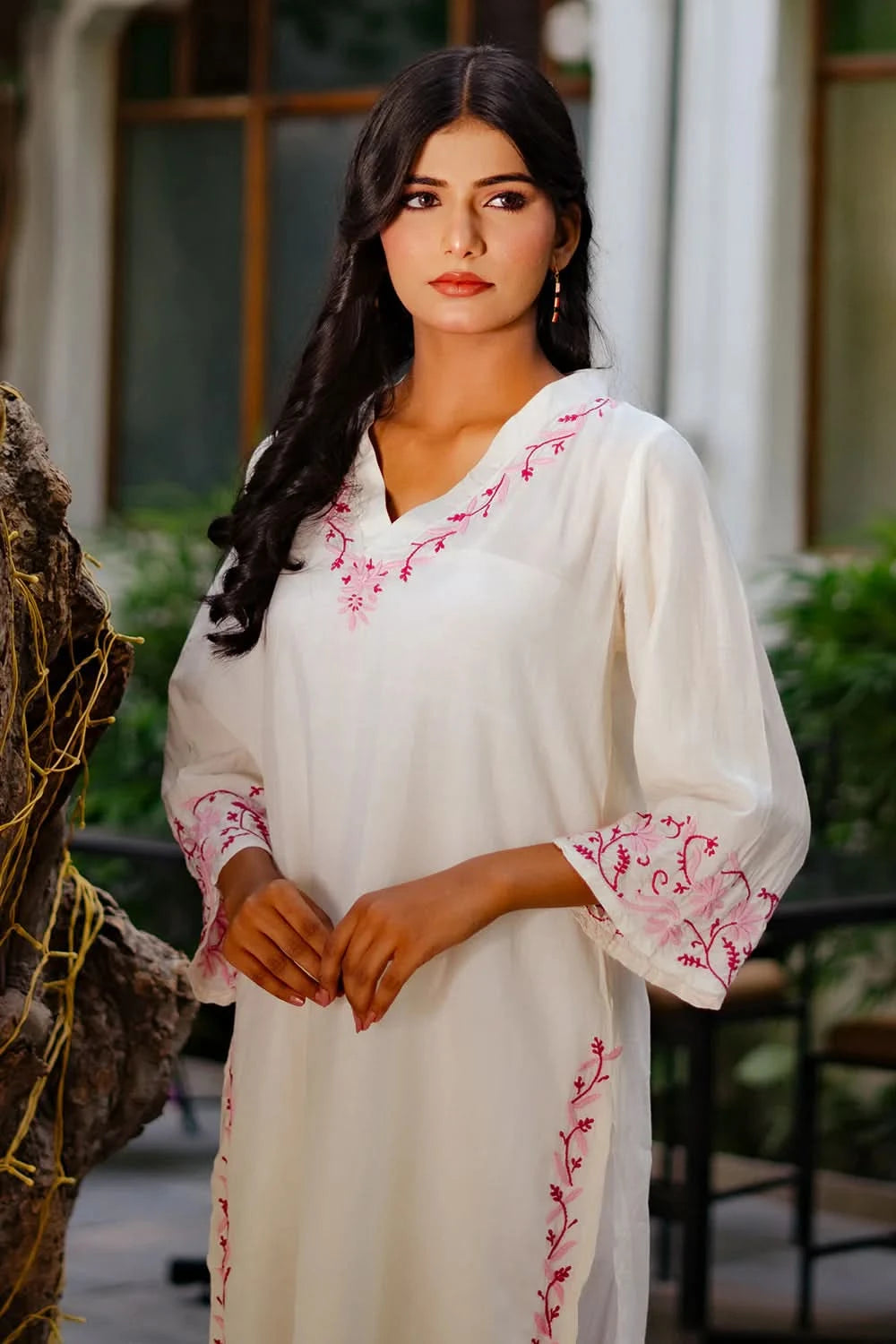 Graceful and breathable white chikankari kurti worn by a woman standing outdoors.