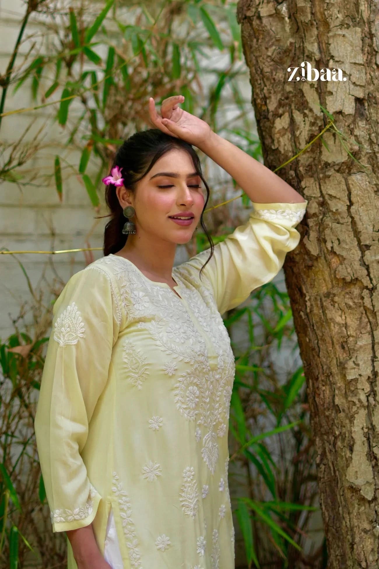 Hand-embroidered yellow chikankari kurti worn by a model outdoors.