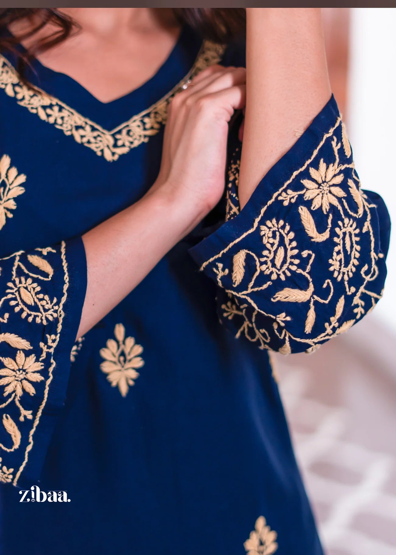 This blue kurta showcases golden embroidery along the V-neckline.
The elegant detailing adds richness to ethnic wear styling. A graceful traditional outfit for weddings and festive wear.