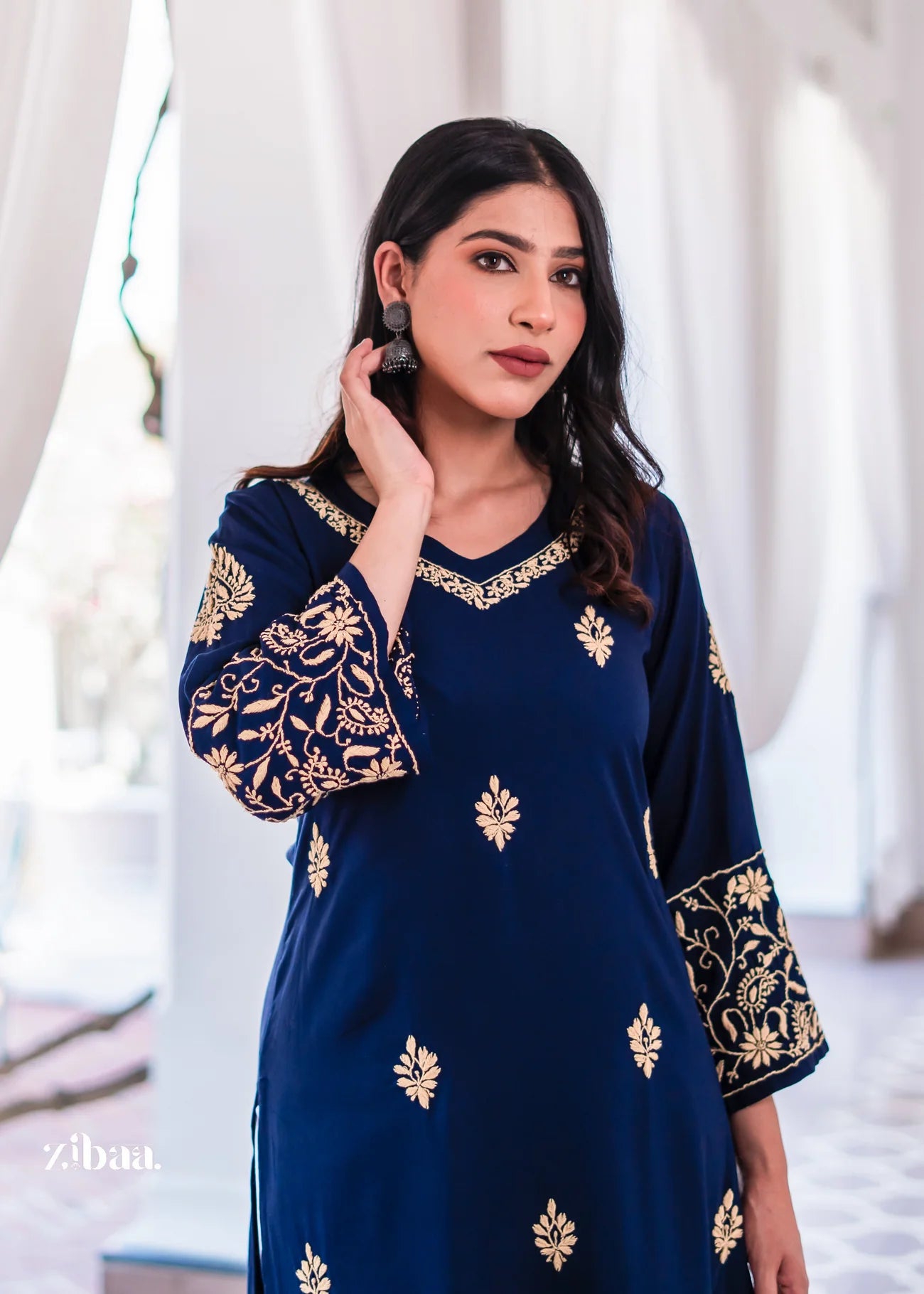 A chic blue kurta with golden embroidery on the neckline and sleeves.
The V-neck cut blends modern style with ethnic wear charm.
An elegant traditional outfit for festive wear and cultural events.