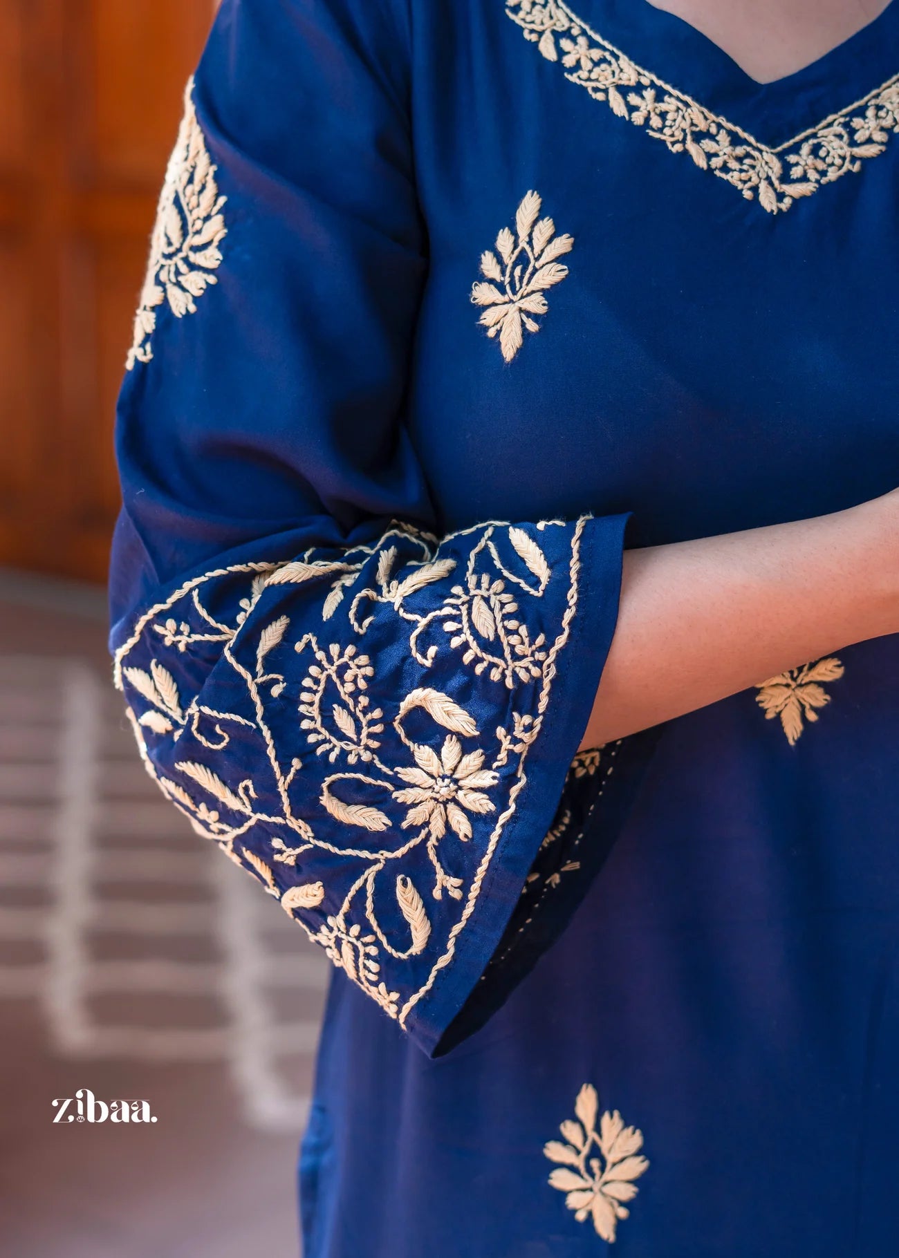 A long blue kurta designed with golden embroidered motifs.
Relaxed silhouette makes it stylish festive wear and ethnic wear. A versatile traditional outfit for both casual and formal occasions.