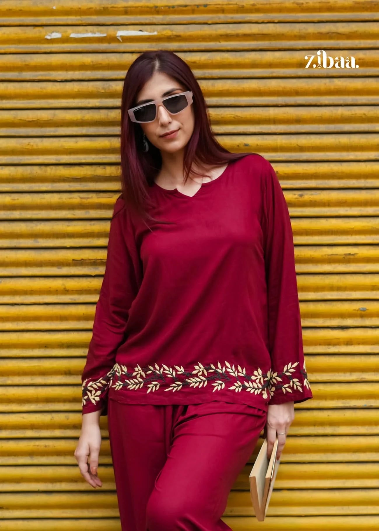 Model standing outdoors in a burgundy chikankari coord set showcasing fine embroidery.