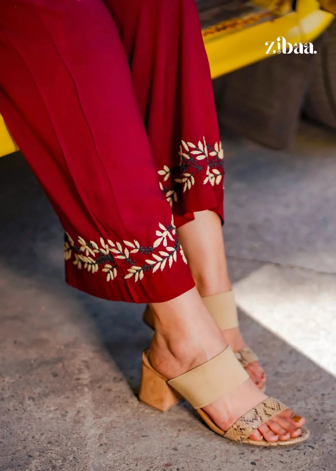Close-up of embroidery detail on pants from a burgundy chikankari coord set.