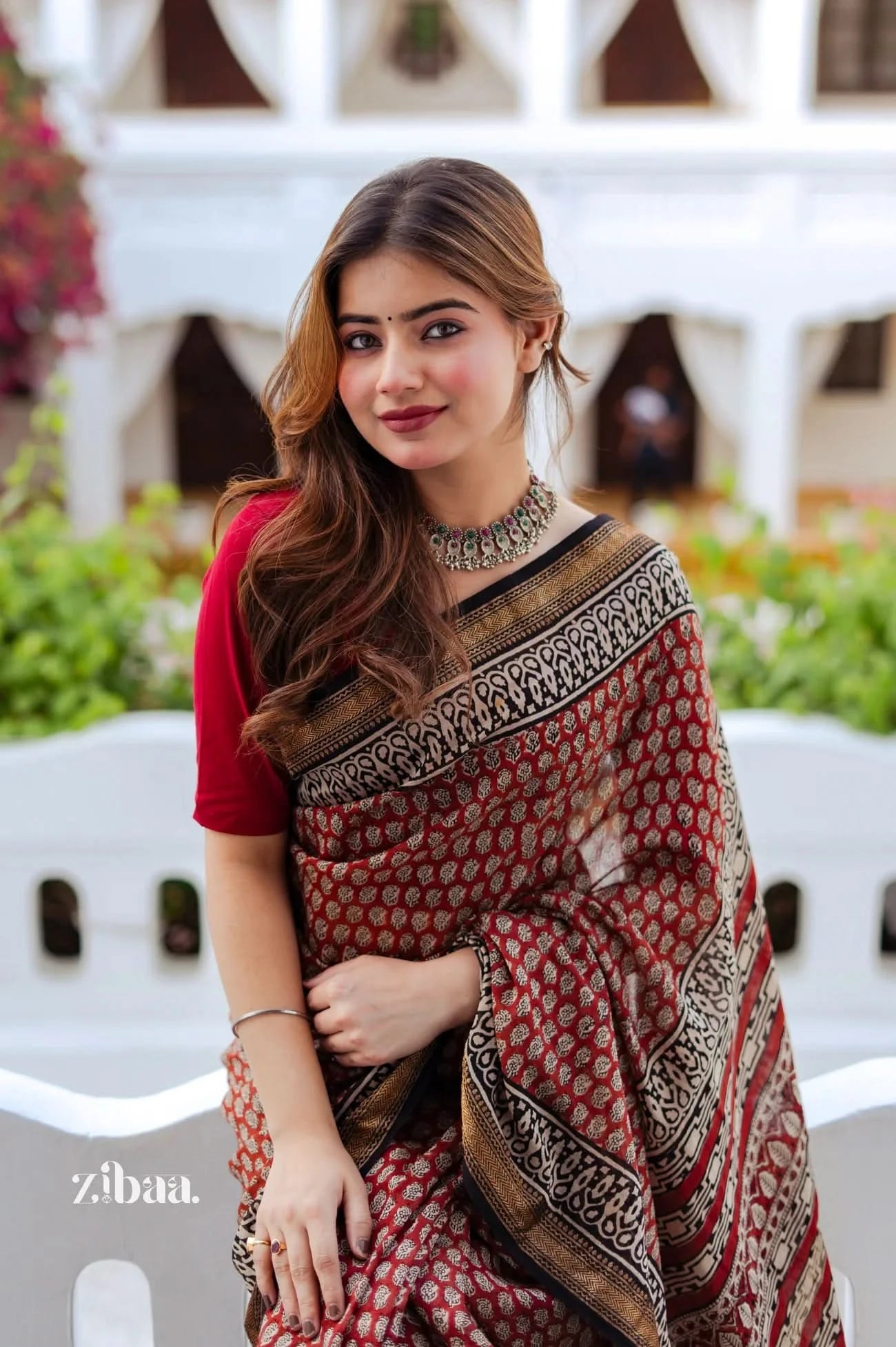 Woman wearing a traditional saree with a blurred background