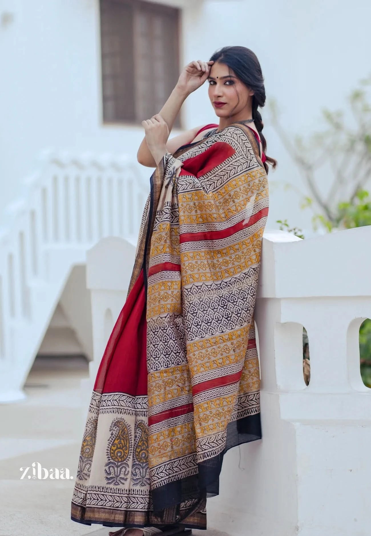 Woman wearing a traditional saree with a white background