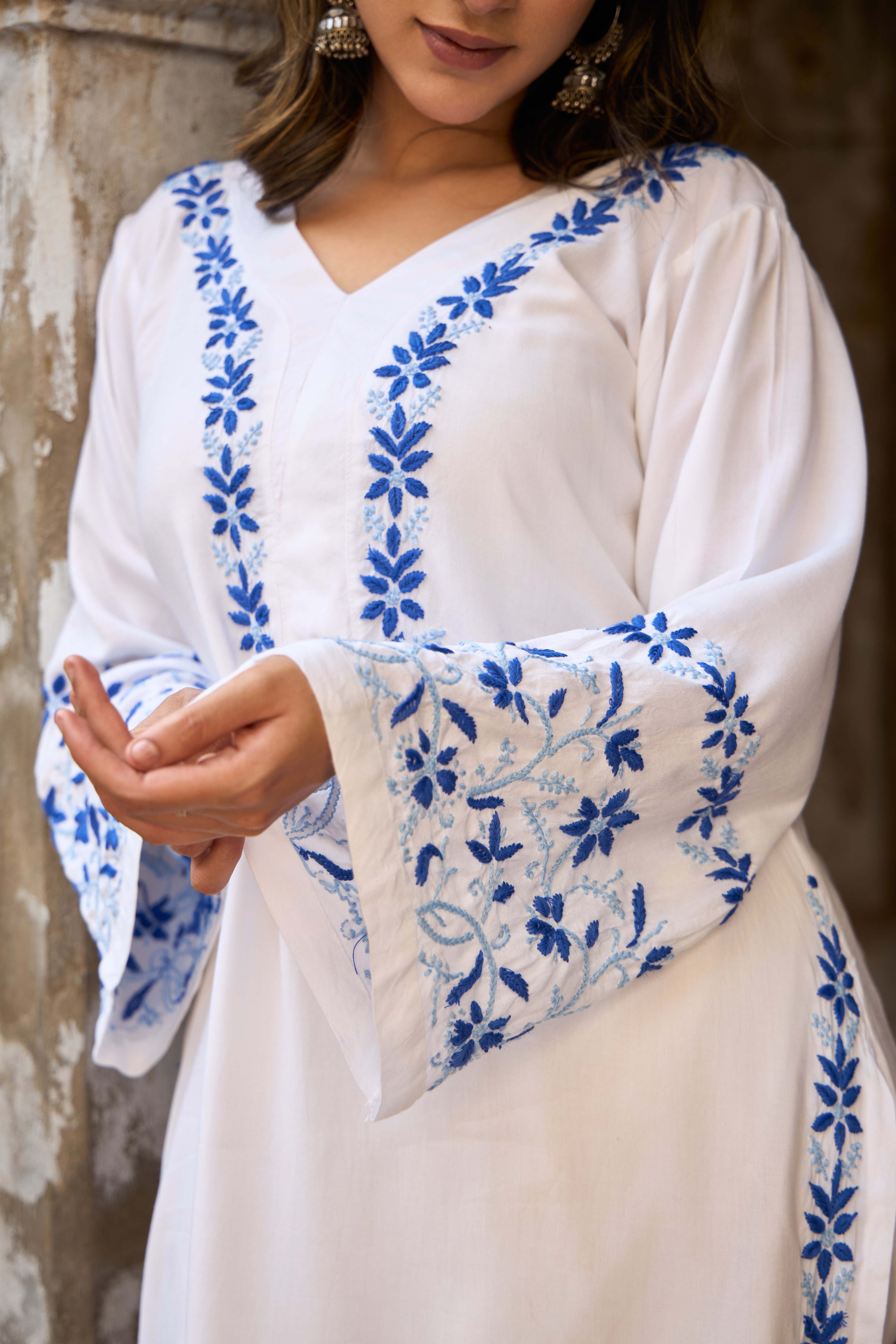 White Chikankari Kurta with blue floral embroidery on a neutral background