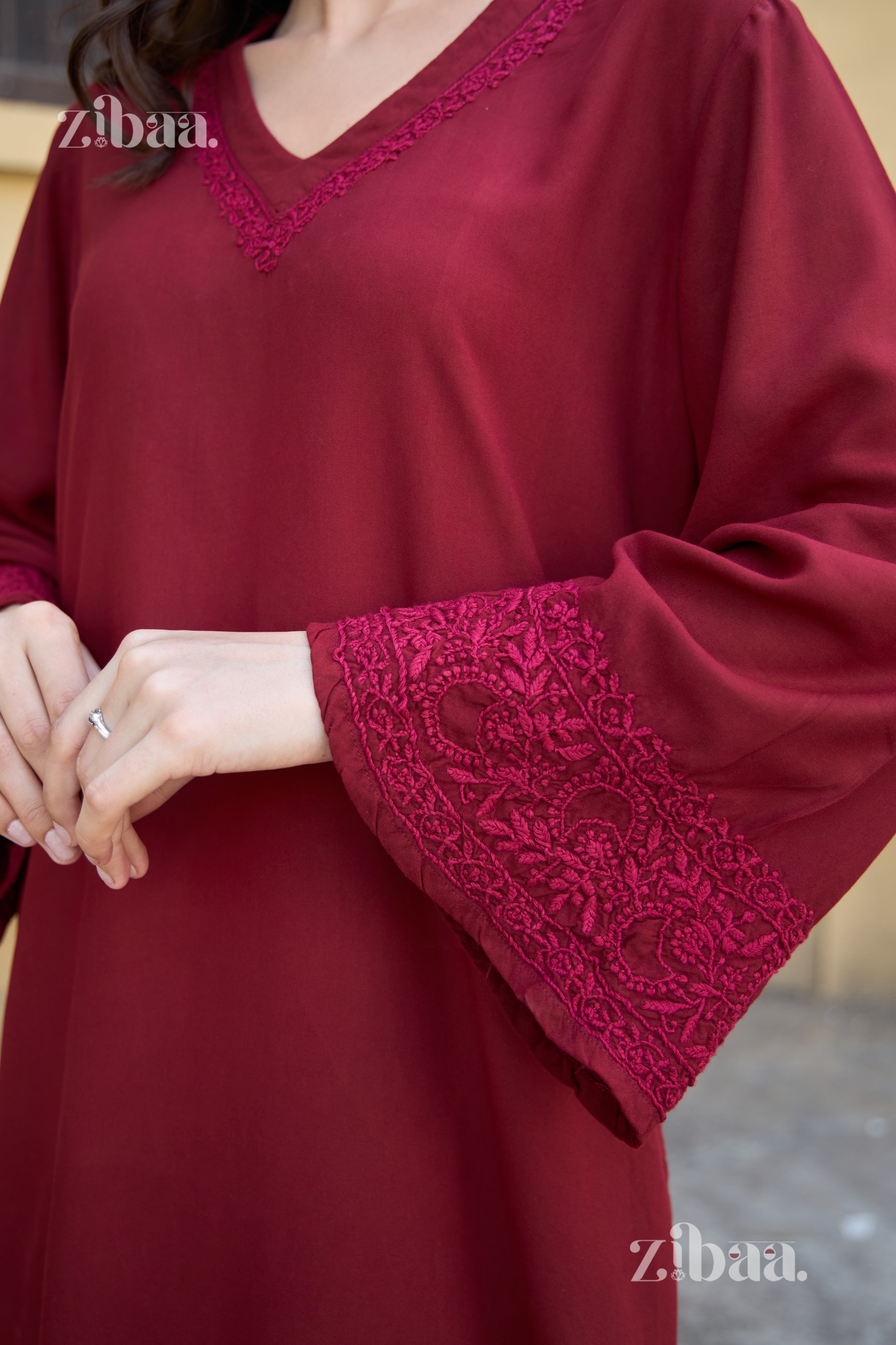 Red dress with lace details on a blurred background
