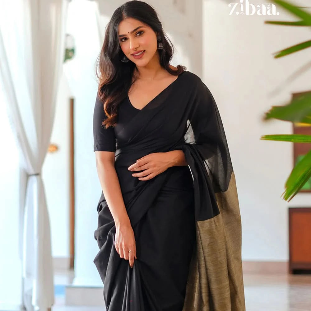Woman wearing a black saree with a zibaa label in the corner