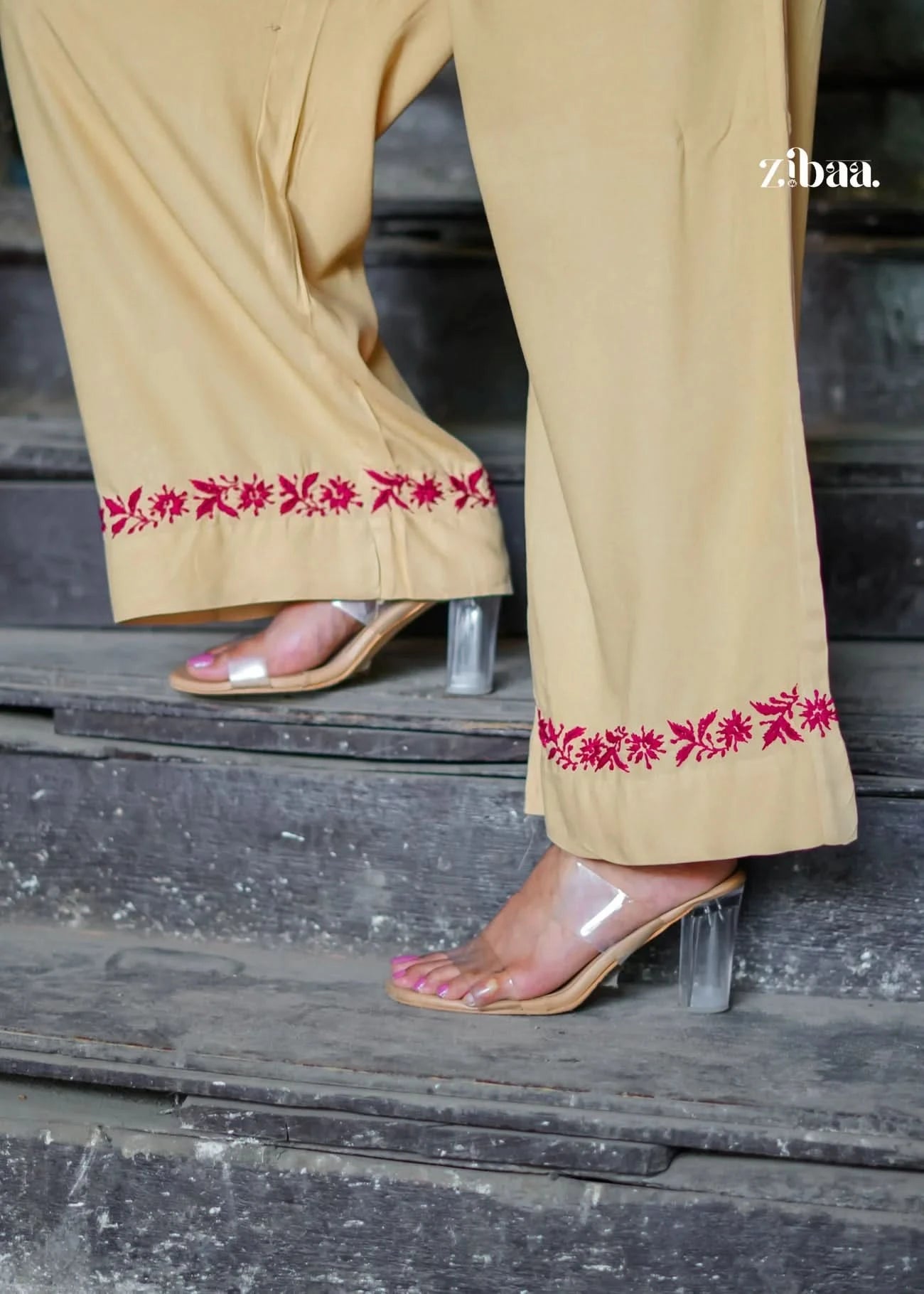 A close-up of the pants from the beige co-ord set with red embroidery. Ideal image to show buyers the quality and finishing of the lower.