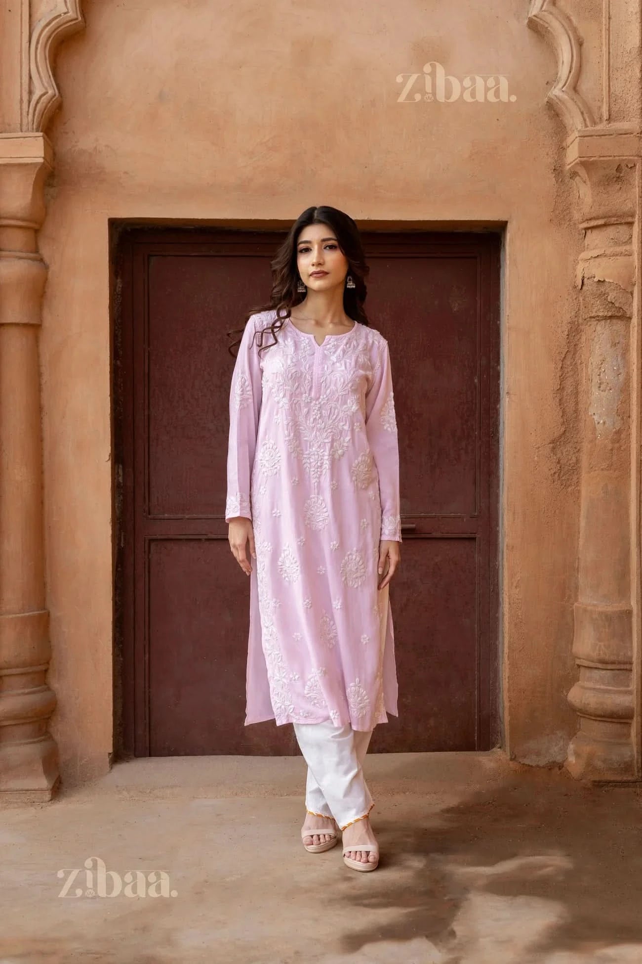 Close-up of a Pink Kurti showcasing intricate white floral embroidery on the neckline and sleeves, highlighting elegant craftsmanship