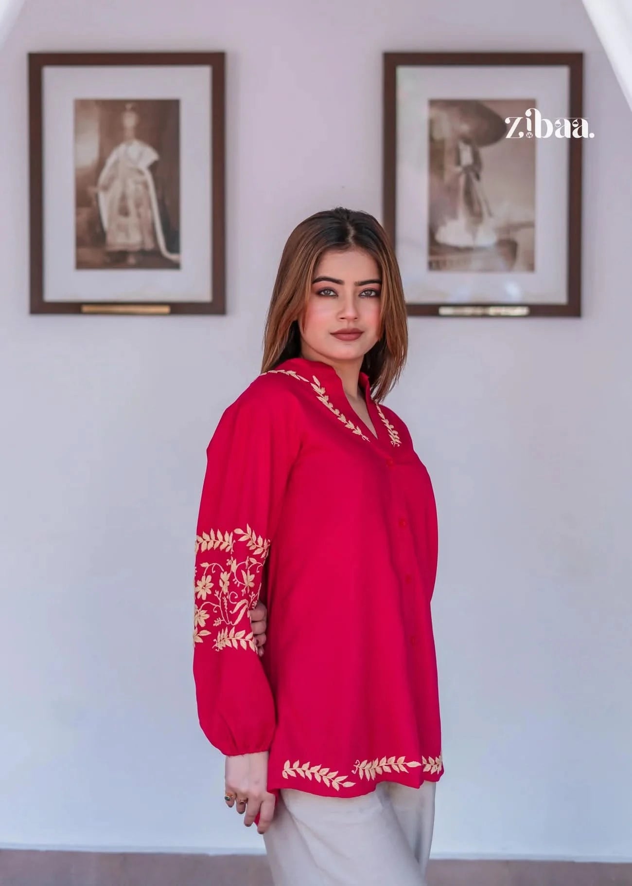 Pink chikankari kurti with golden embroidery worn by model outdoors.