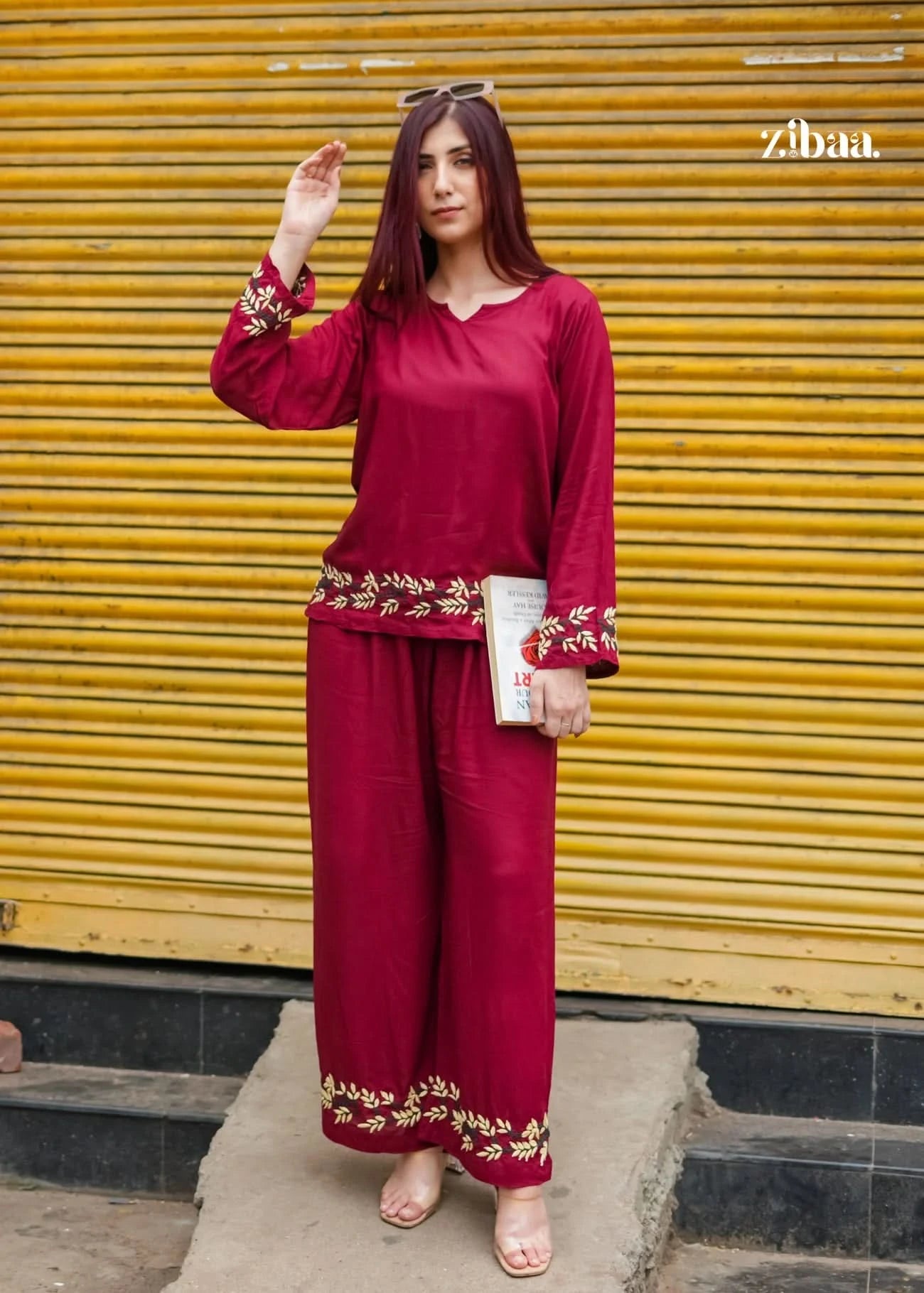 Model posing in a burgundy chikankari coord set outdoors with fine embroidery accents.