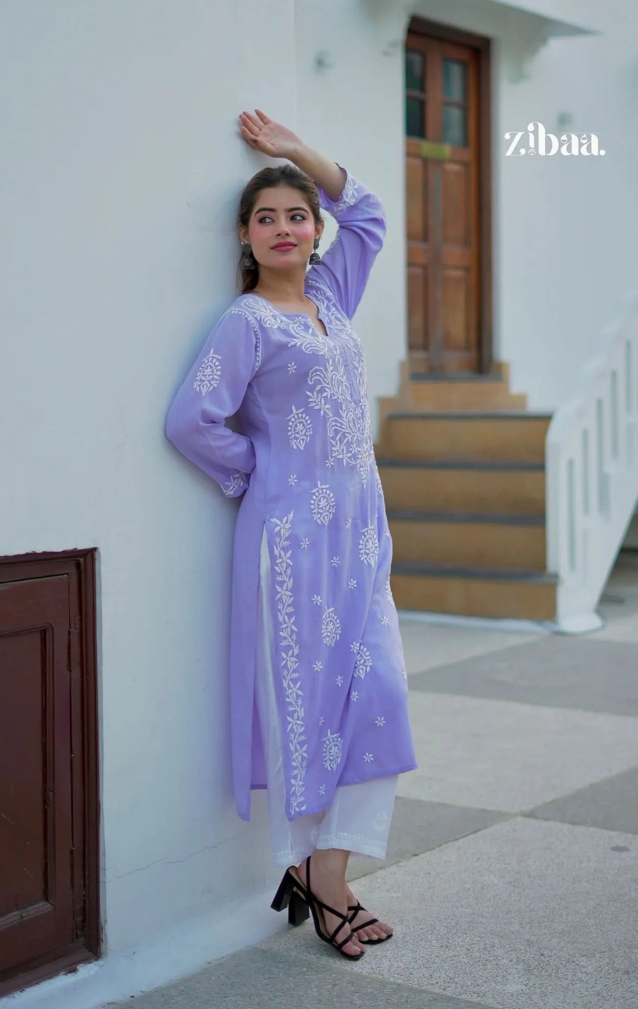 Lavender chikankari kurti with fine traditional embroidery worn by a model in an outdoor setting.