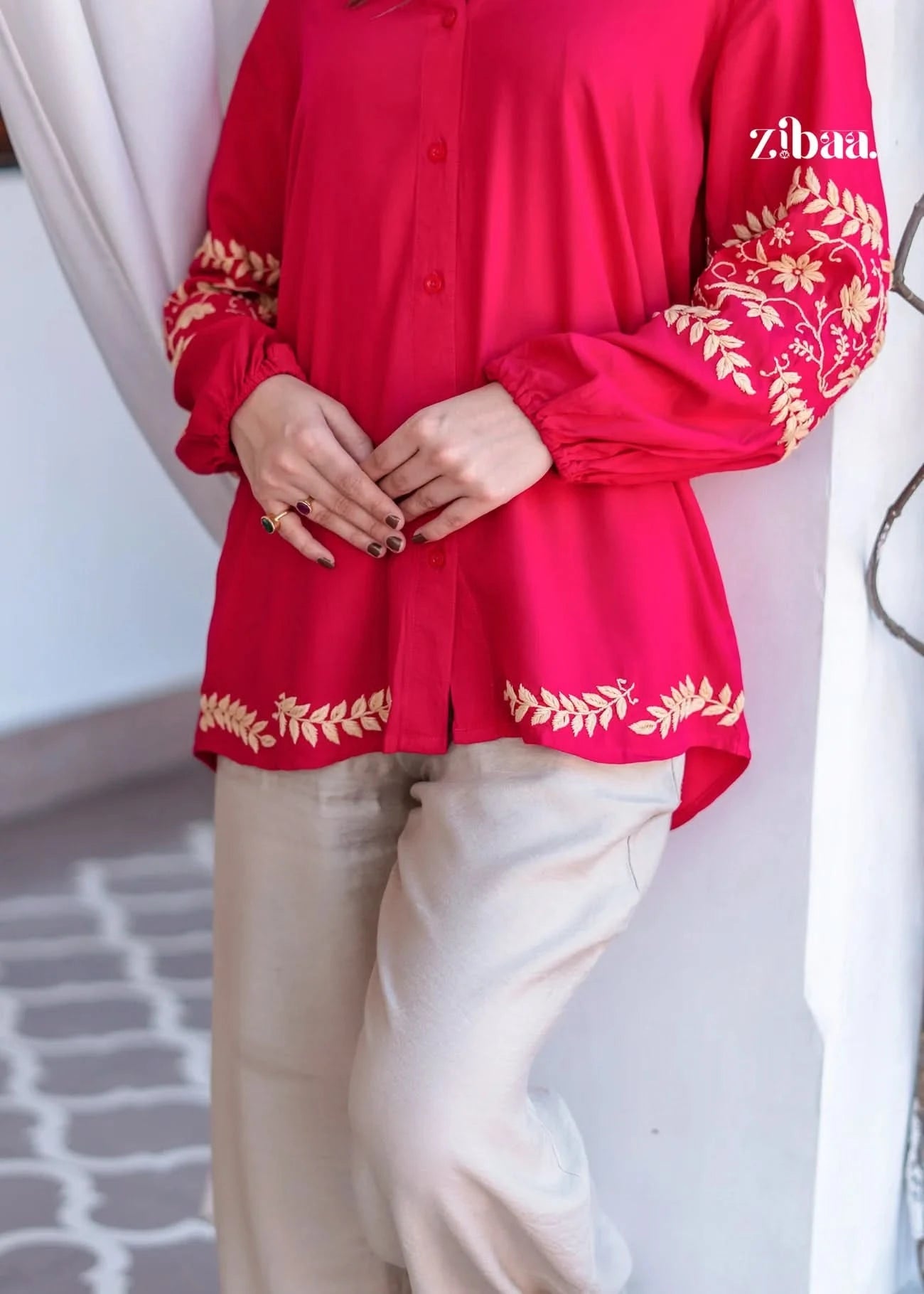 Outdoor close-up shot of model wearing a pink chikankari kurti with fine embroidery.