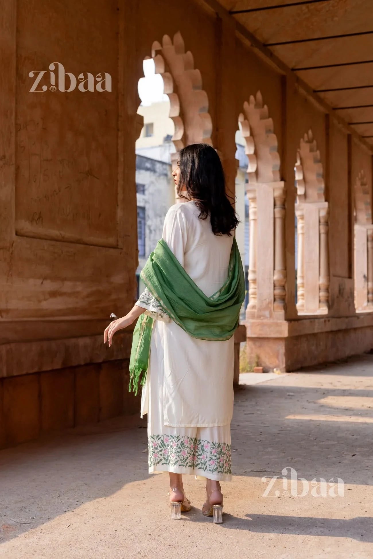 Floral embroidered White Chikankari Kurta Set worn by a woman, styled with a soft sage green mulmul dupatta.