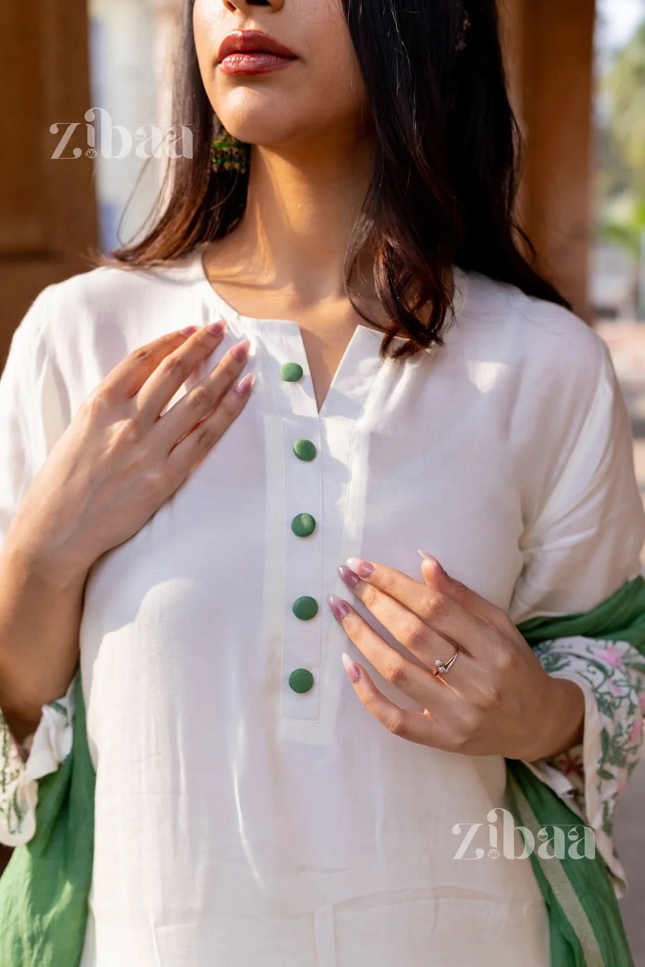 Model in a traditional White Chikankari Kurta Set with floral embroidery, paired with a sage green mulmul dupatta.