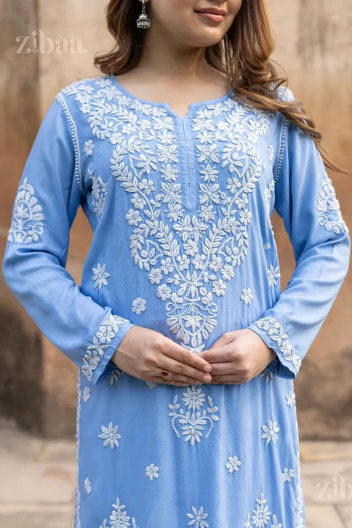 Model in Blue Chikankari Kurta with intricate white embroidery, posing elegantly from front and side angles near a historic monument
