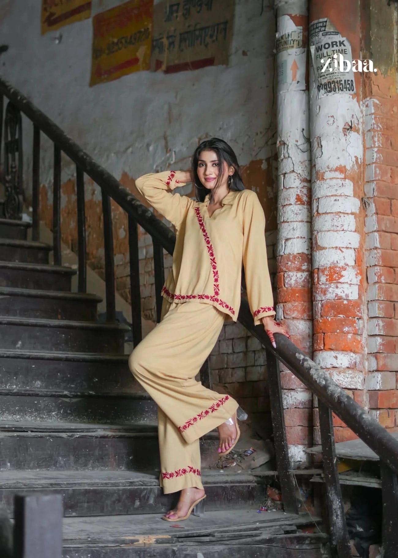 A full look at the two-piece beige ensemble, showcasing relaxed fit and embroidered detailing. Set in a heritage backdrop, this outfit merges comfort with ethnic charm.
